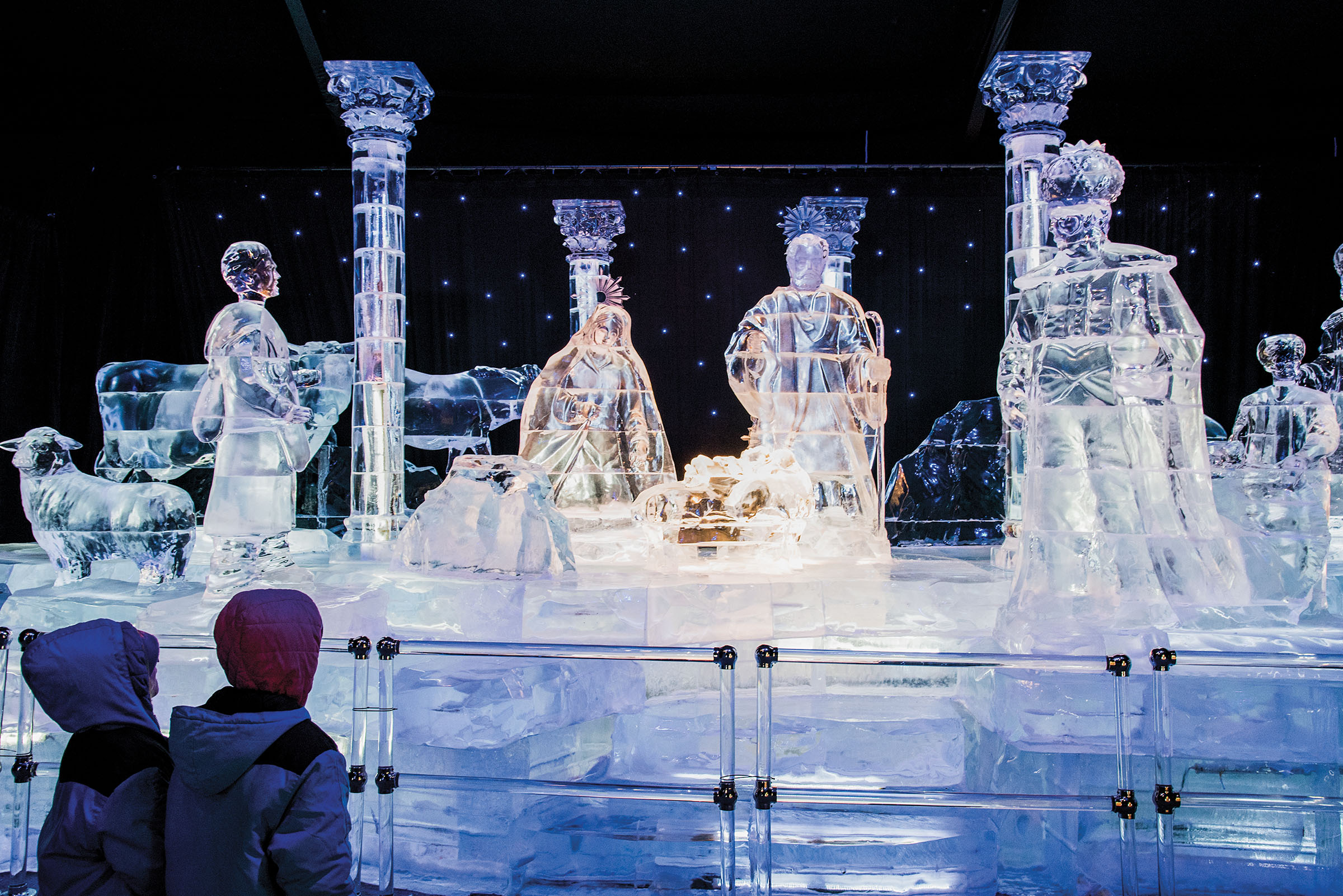 Brightly lit and tall ice sculptures on a dark background