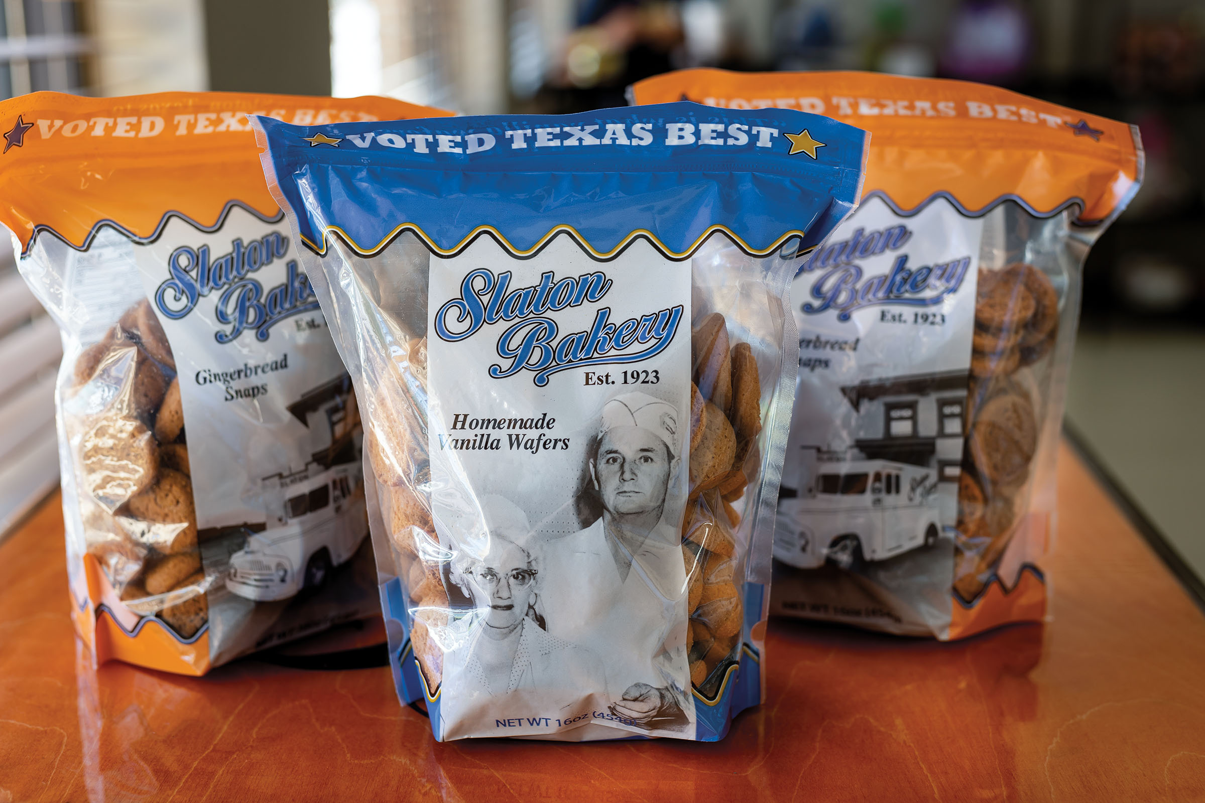 Three bright blue and orange bags filled with cookies