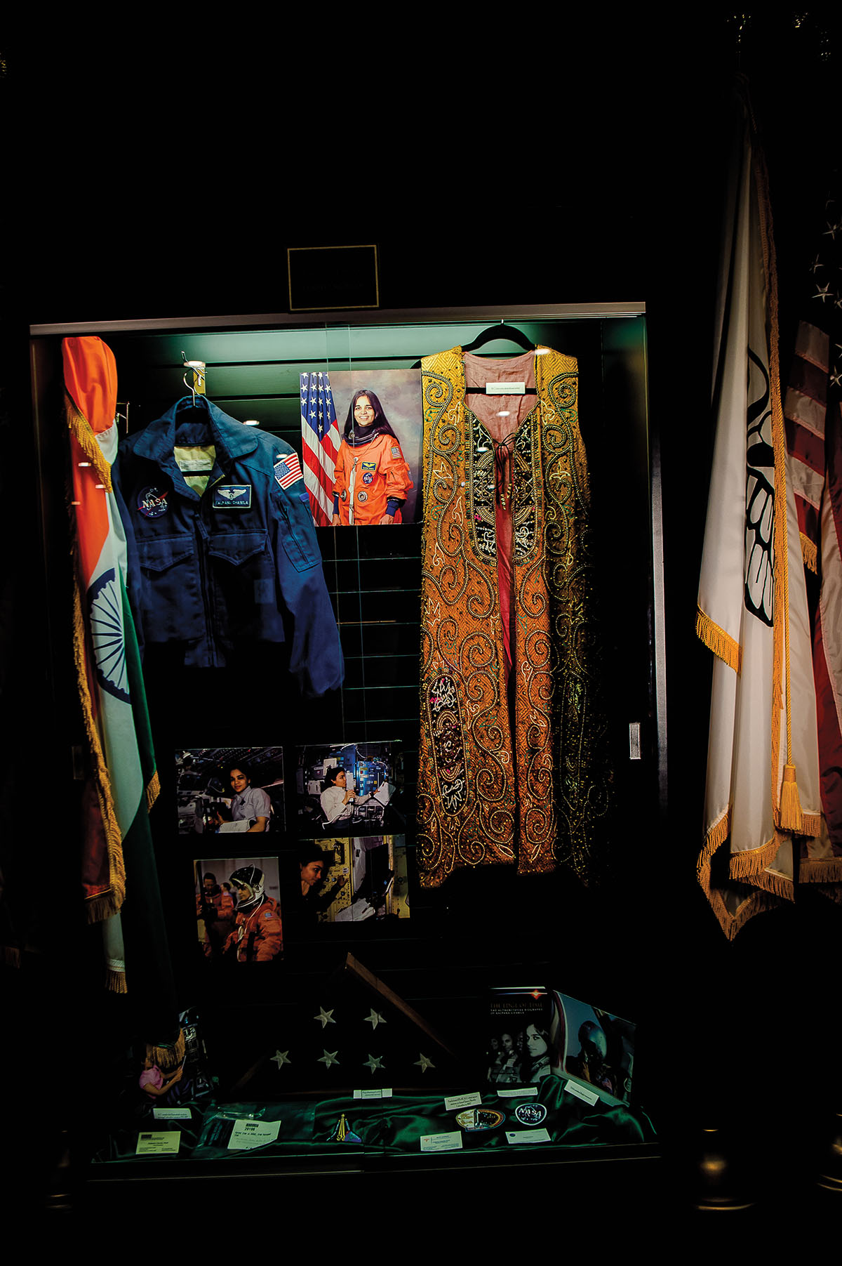 A collection of photographs, flags, clothes, and other memorabilia of a woman astronaut on the Columbia mission