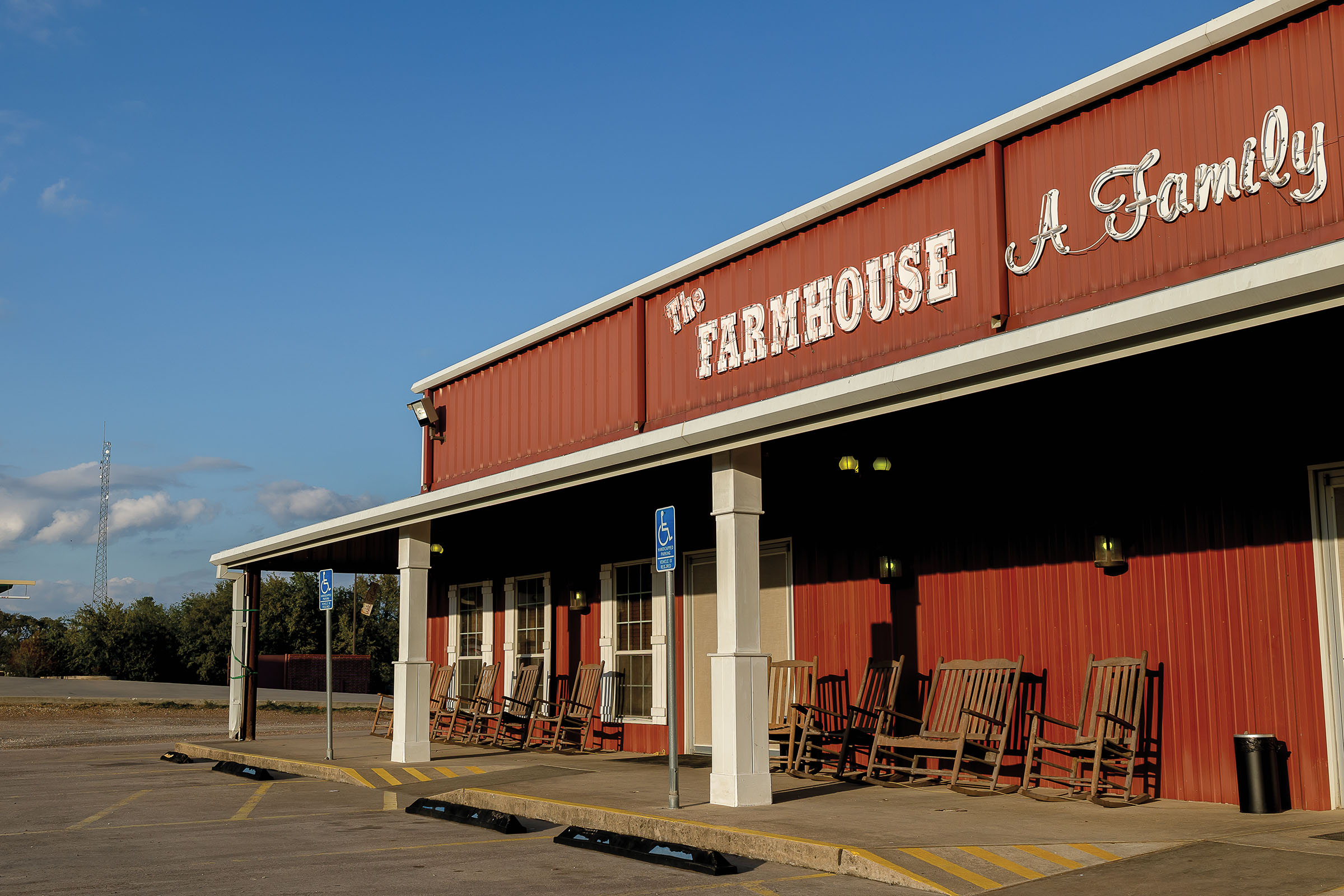 The exterior of a red restaurant with white text reading "The Farmhouse"