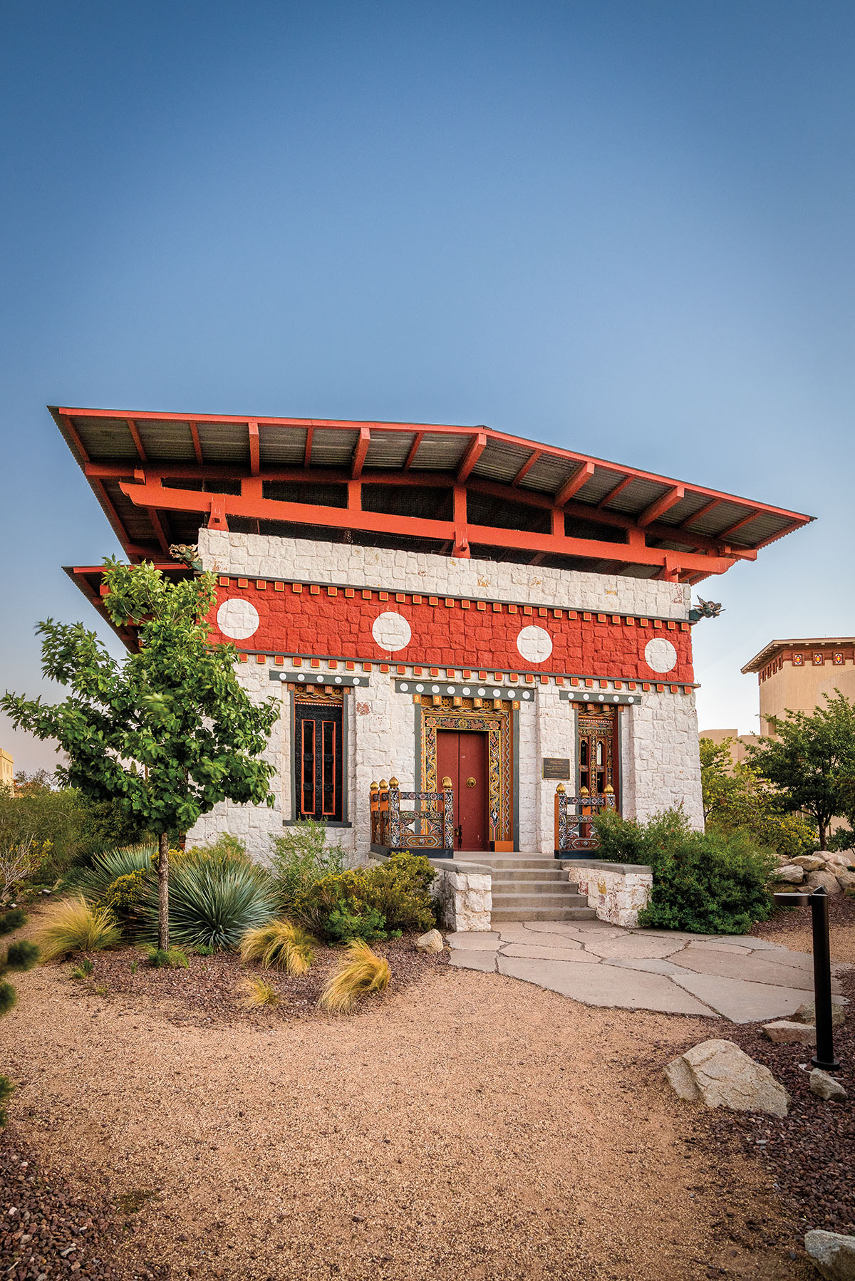 The exterior of a building with Asian-influenced architecture and bright red and white paint