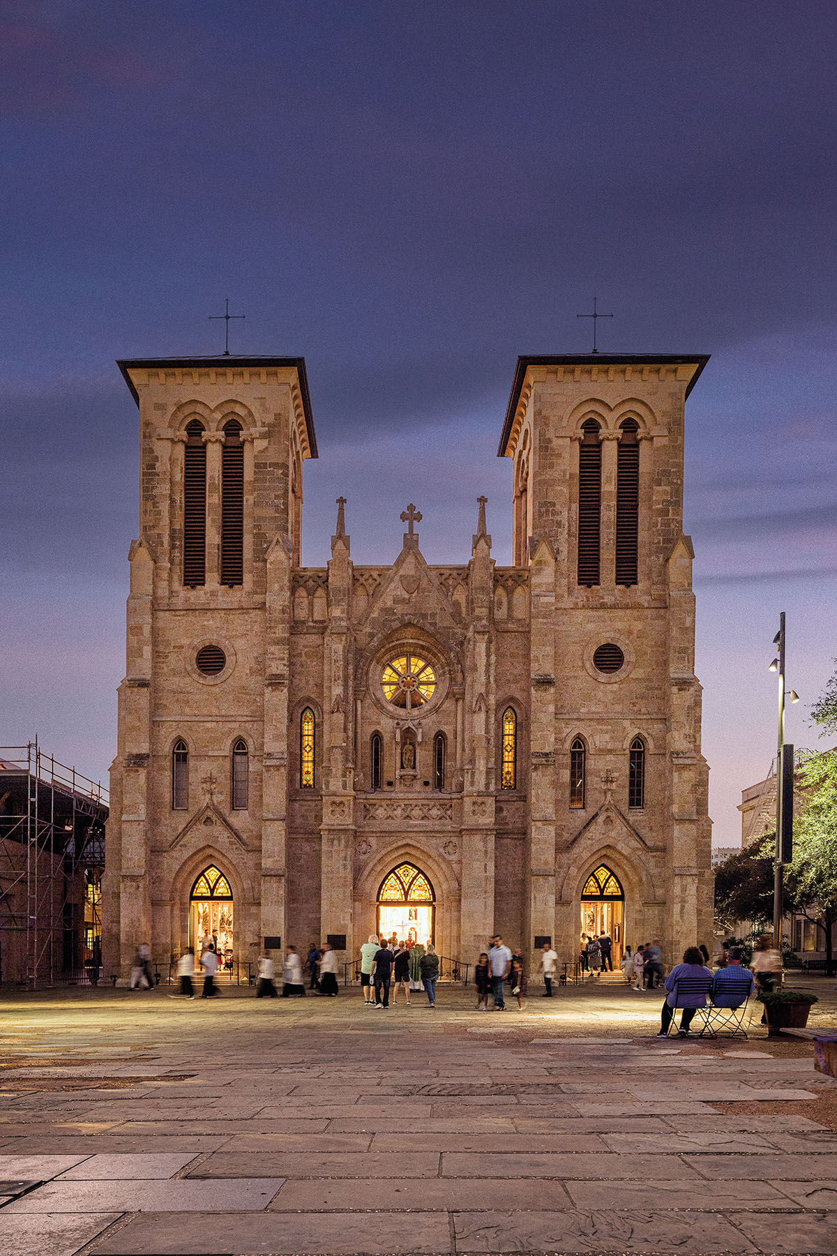 The exterior of a large grand chapel brightly illuminiated against a dark purple sky