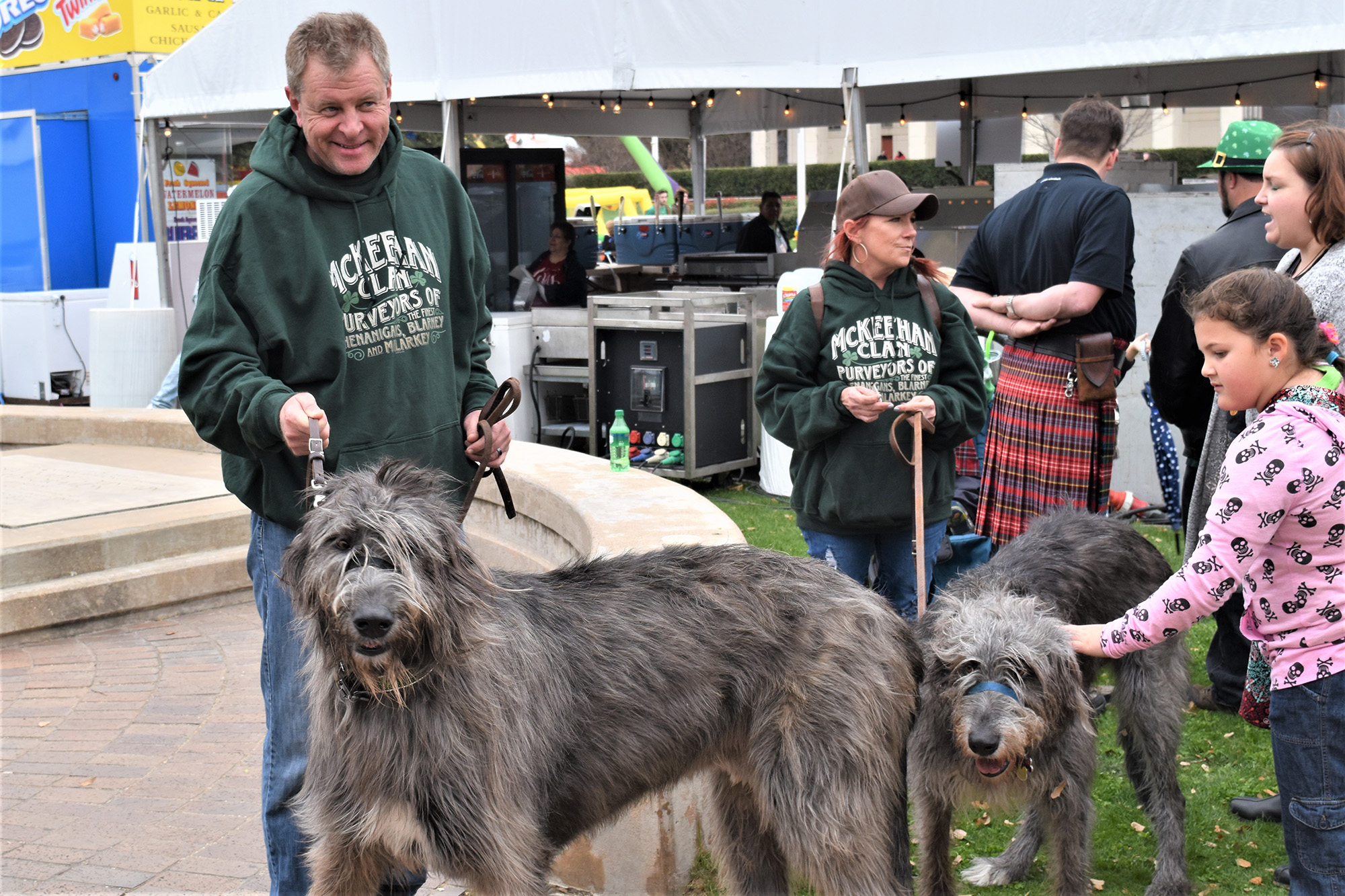 Two Irish Wolfhounds and their owners attending the festival