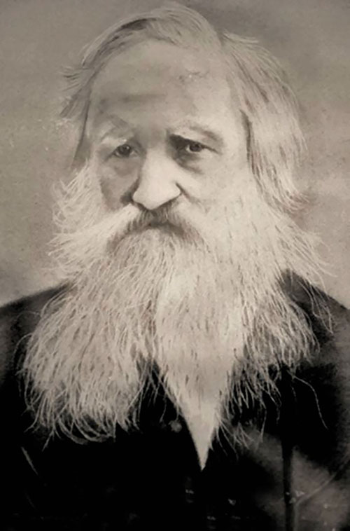 A historic portrait of a man with a large white beard