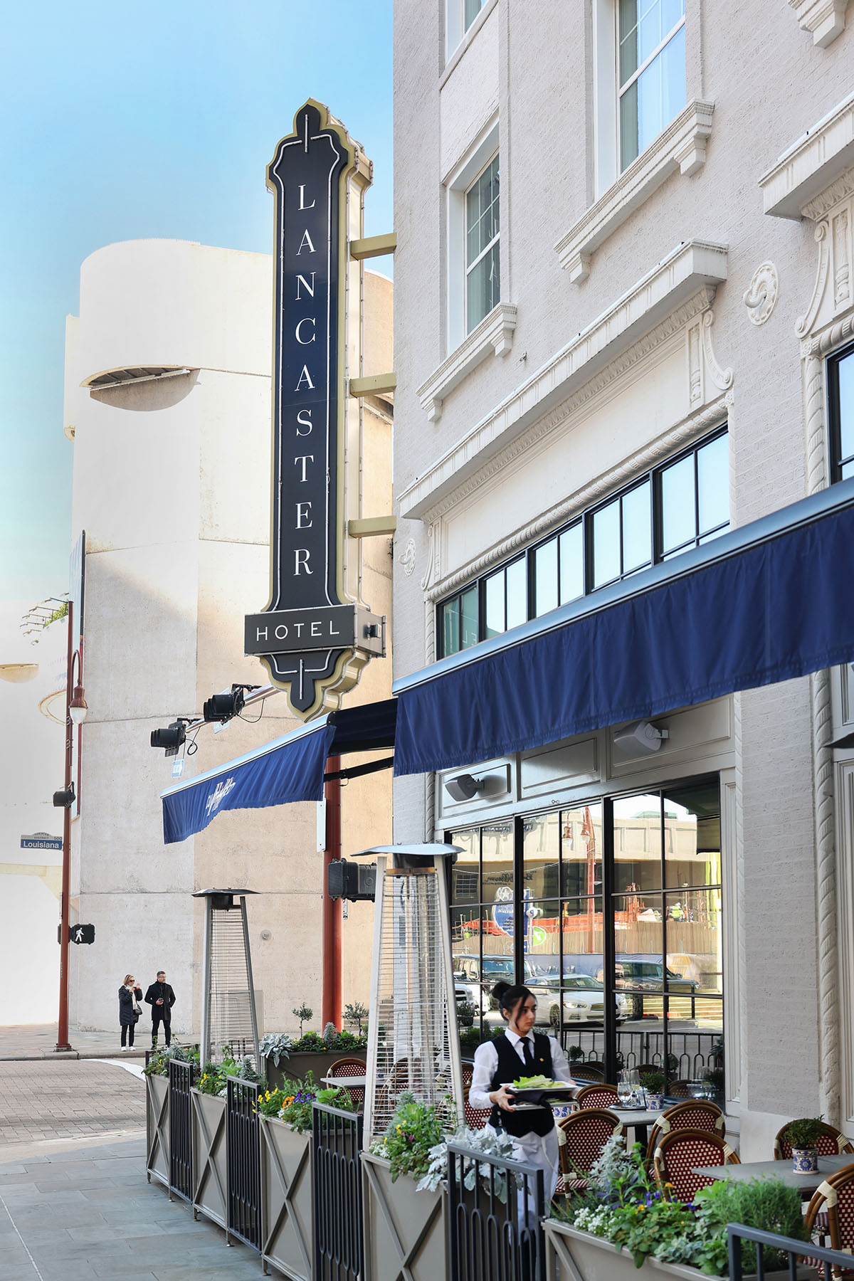 The exterior of a historic hotel with a large sign reading "Lancaster"