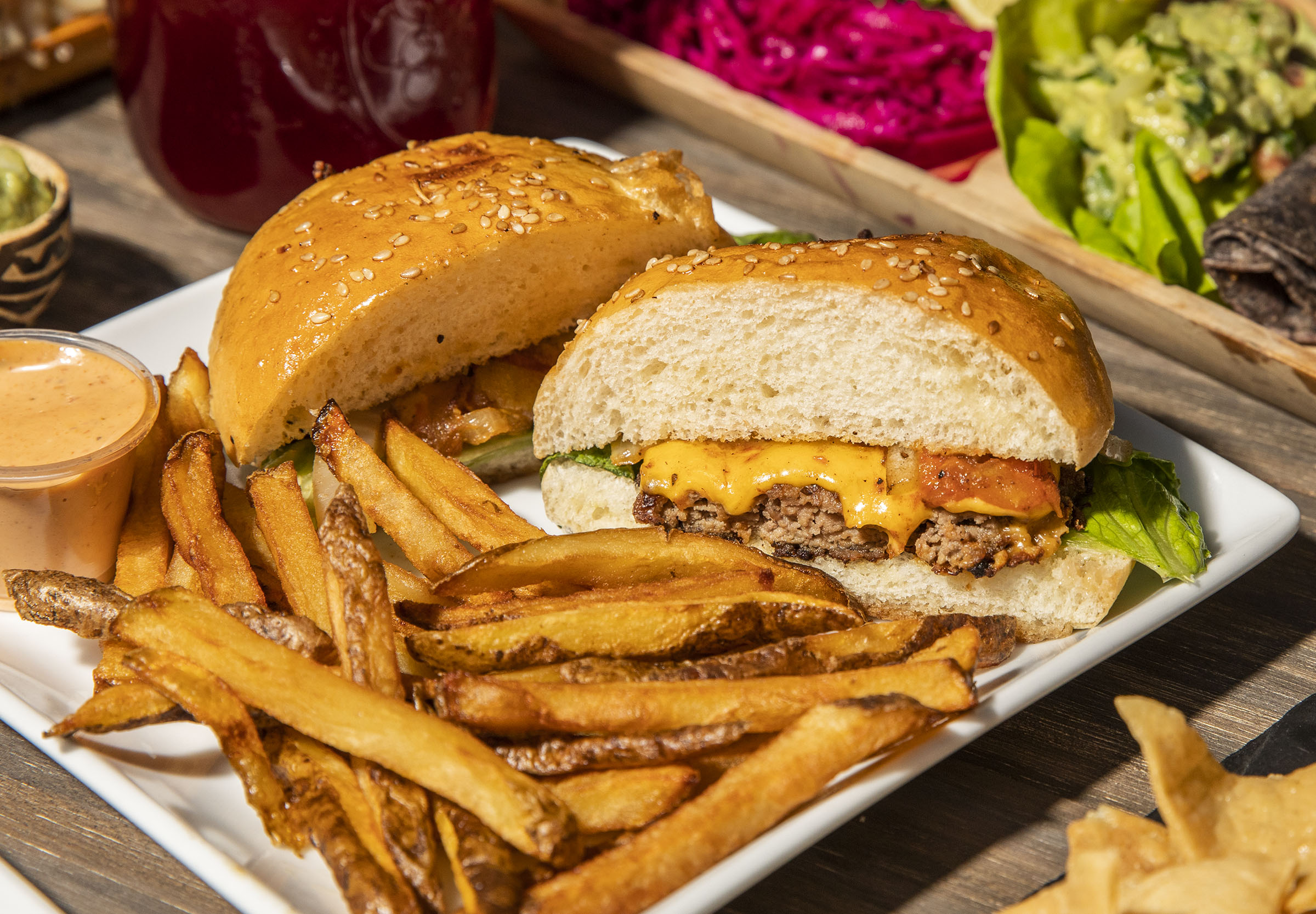 A burger and fries on a steel platter