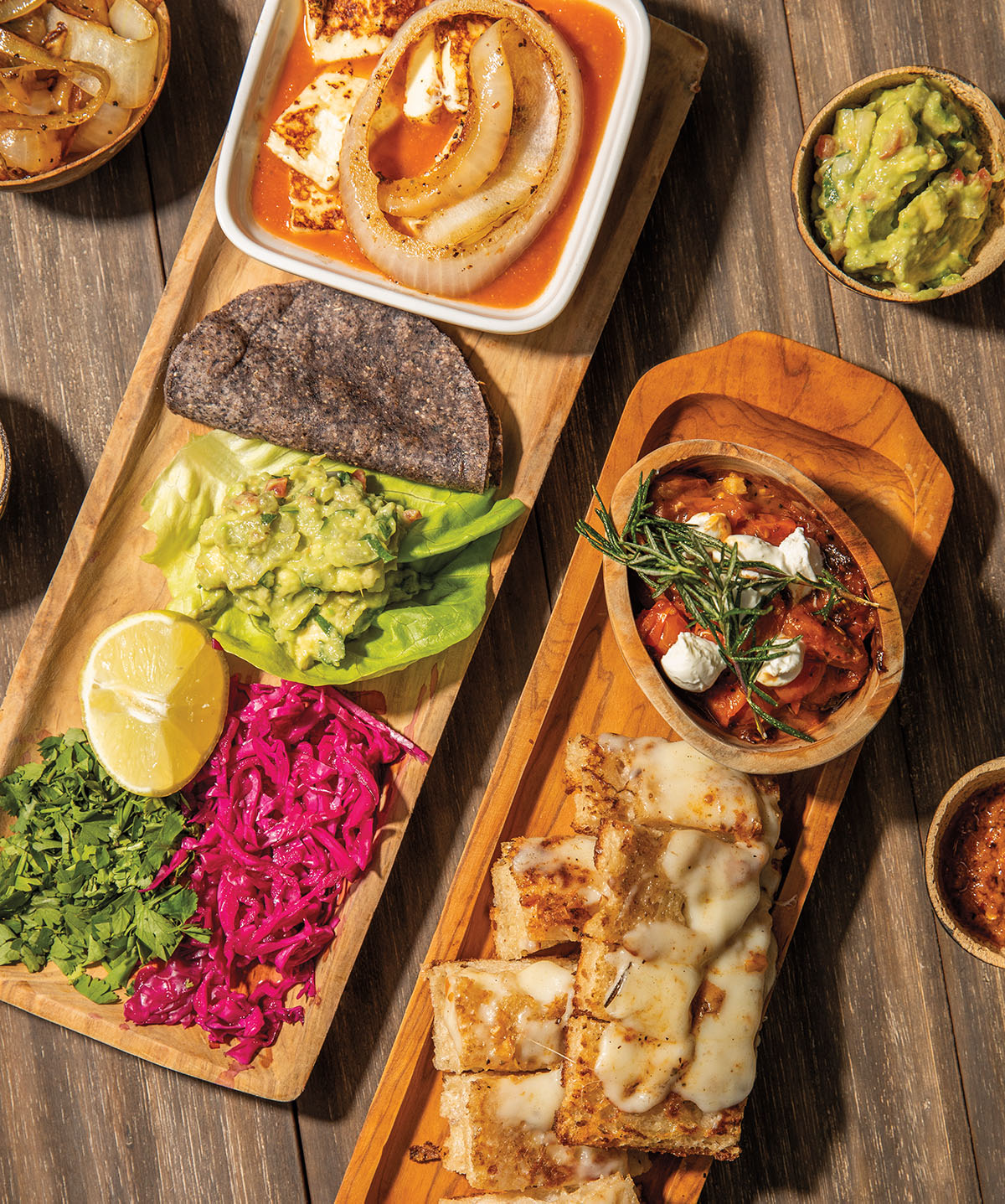 An overhead view of brightly colored dishes on wooden trays