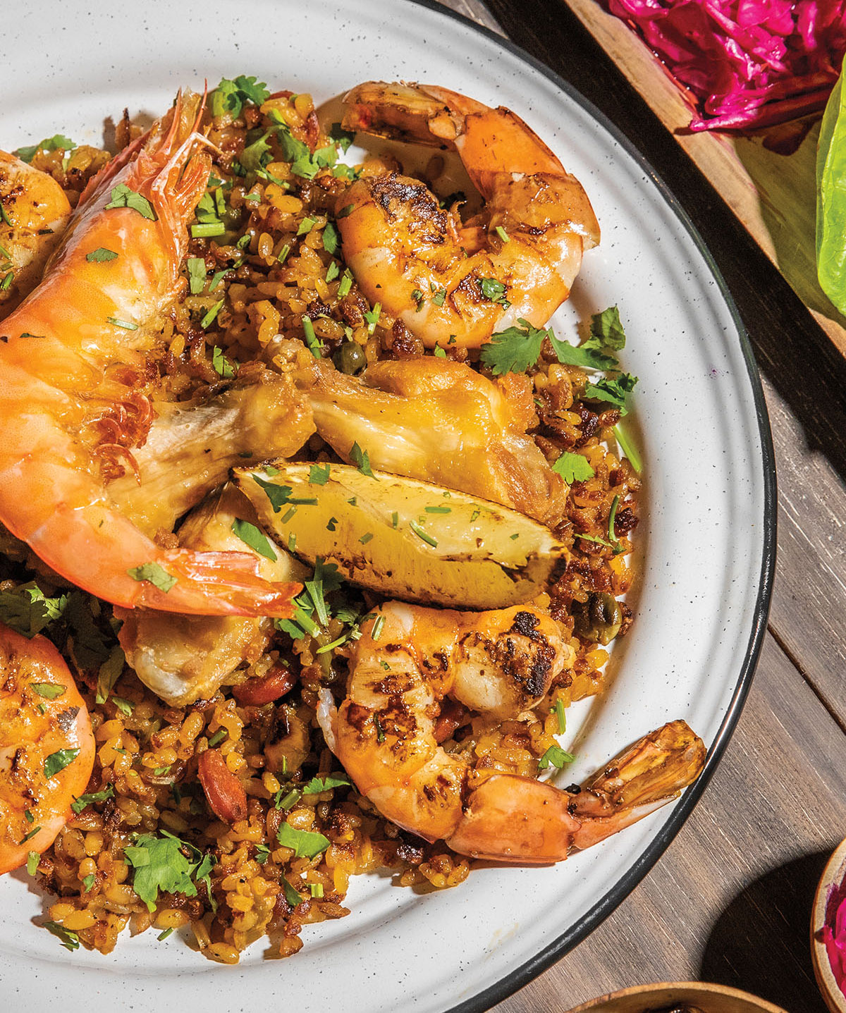 An overhead view of a plate of paella with shrimp and rice