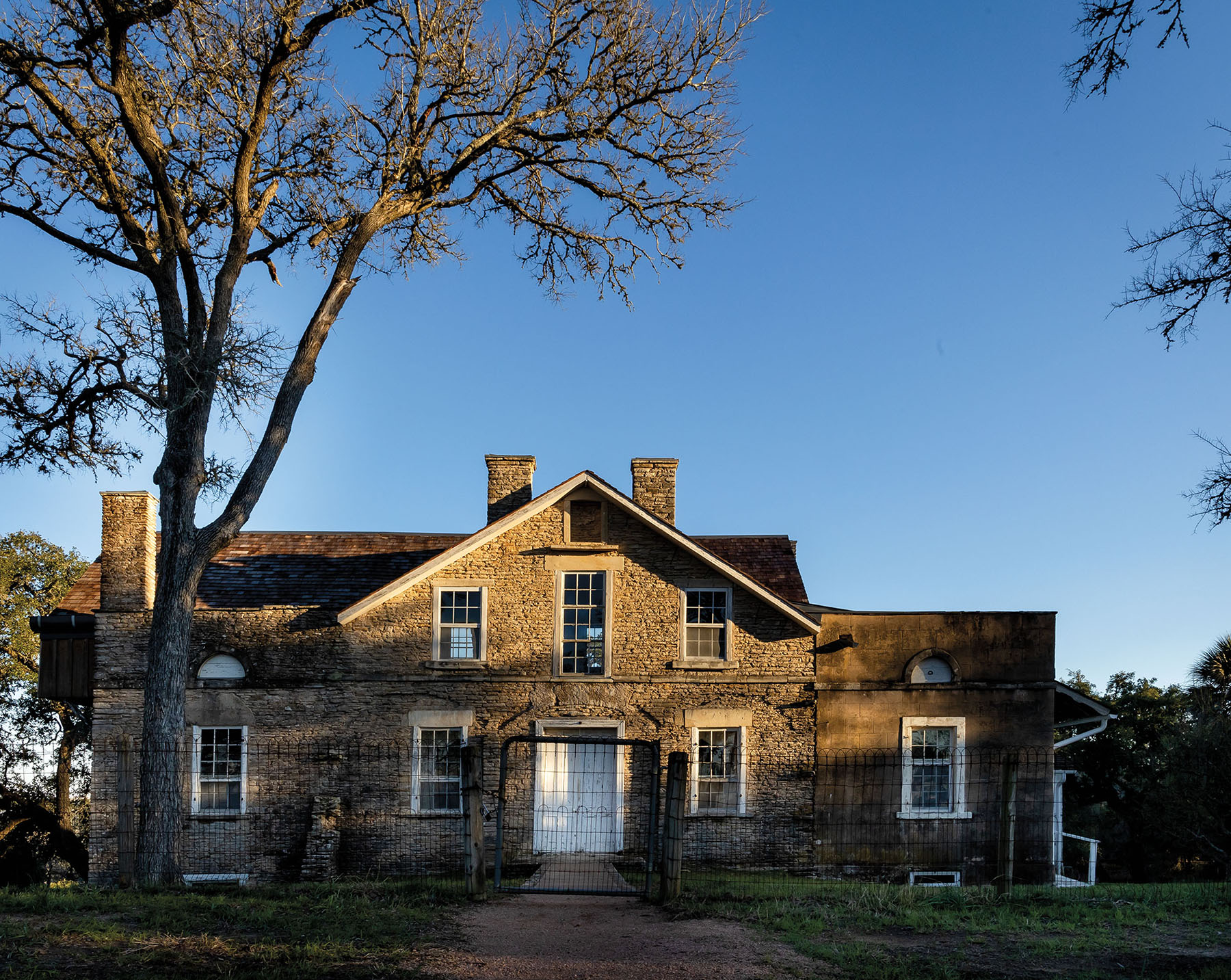 The exterior of a historic home under blue sky