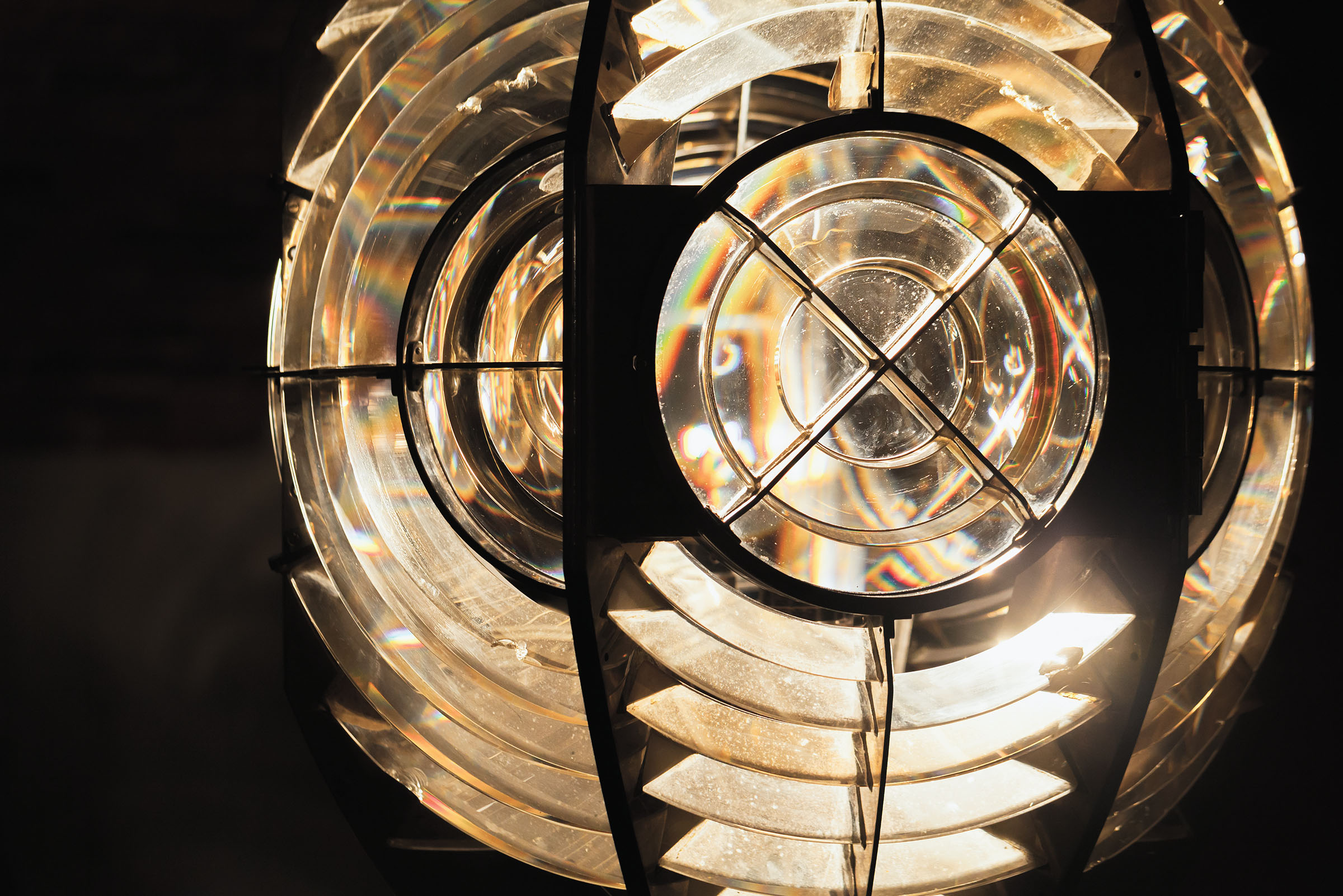 Close up photo.of a ;ighthouse lamp with a Fresnel lens. It is a type of composite compact lens developed by the French physicist Augustin-Jean Fresnel for use in lighthouses