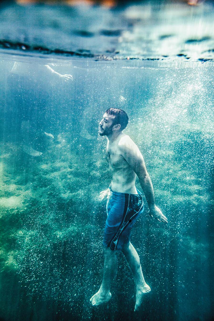 A man below the surface of Jacob's Well after a dive.