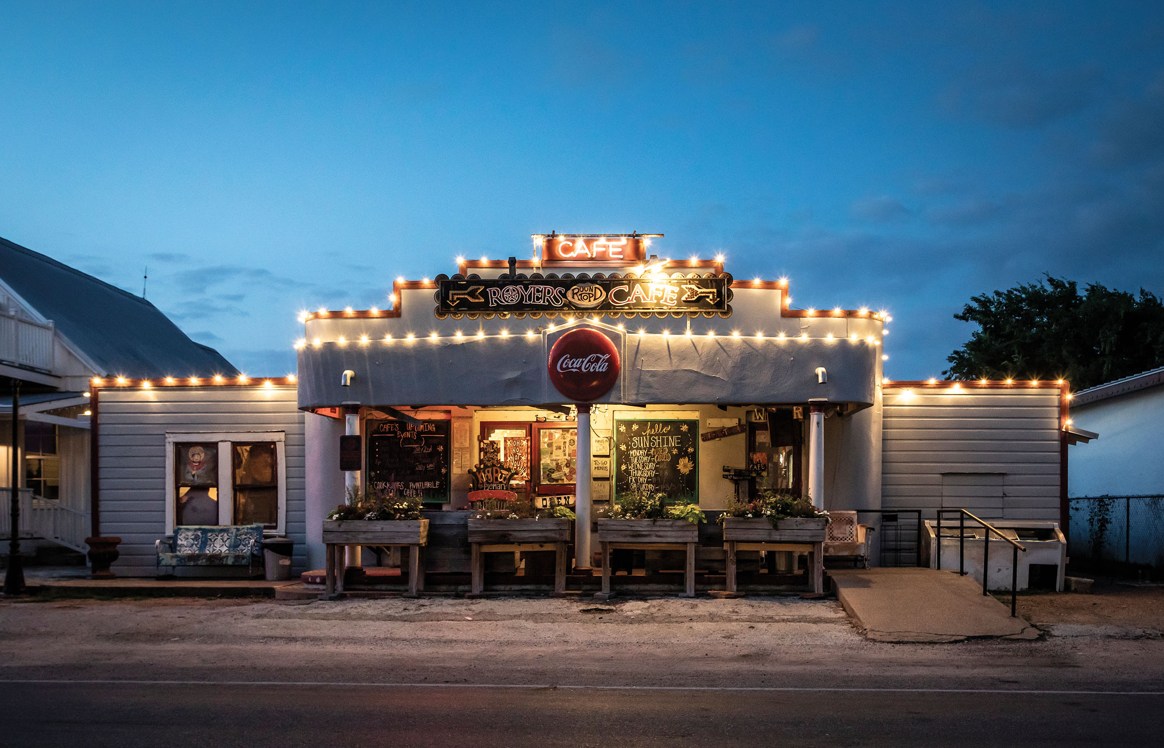 An old-fashioned building adorned with string lights in a nighttime scene