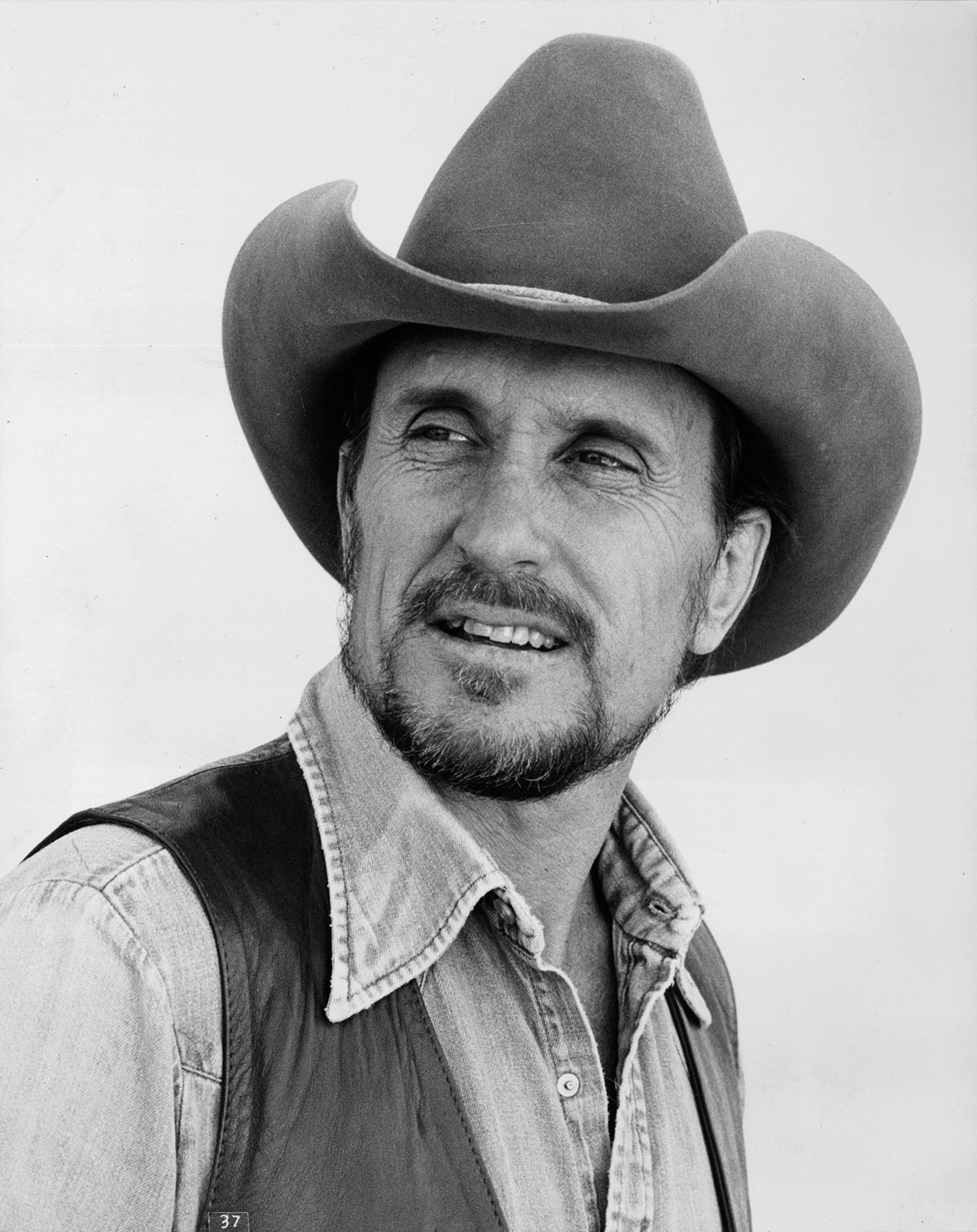A black and white image of a man in a cowboy hat