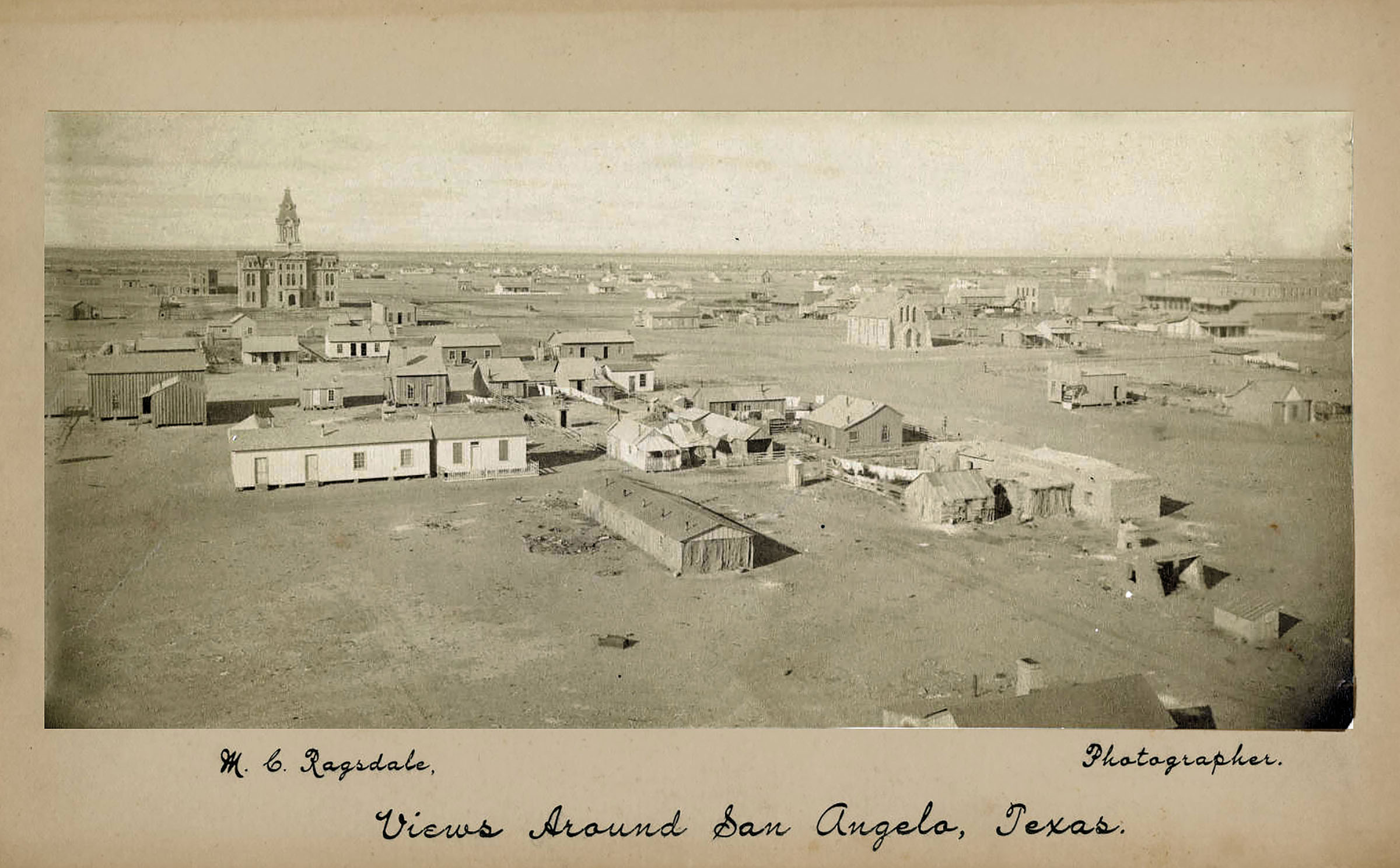 A sepia-tone historic photo of a town