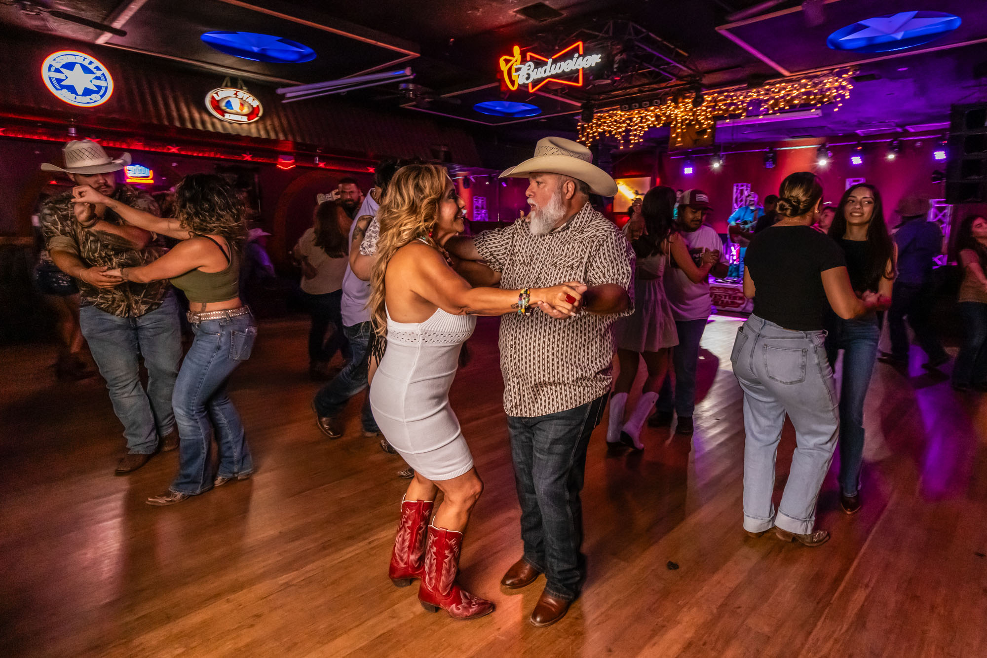 An older gentleman and lady dancing together