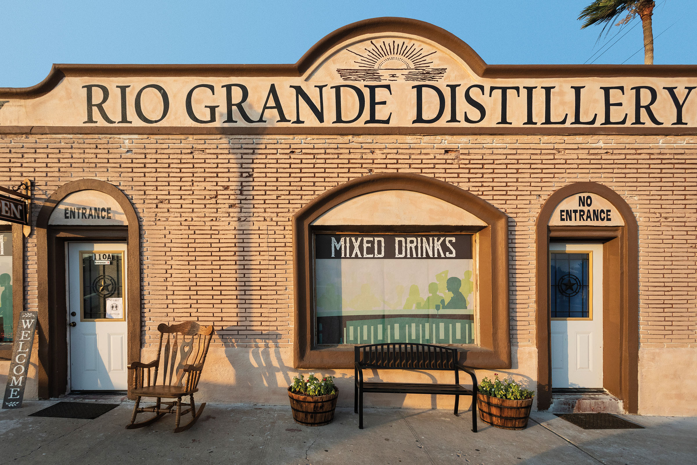 Front of brown building titled "Rio Grande Distillery."