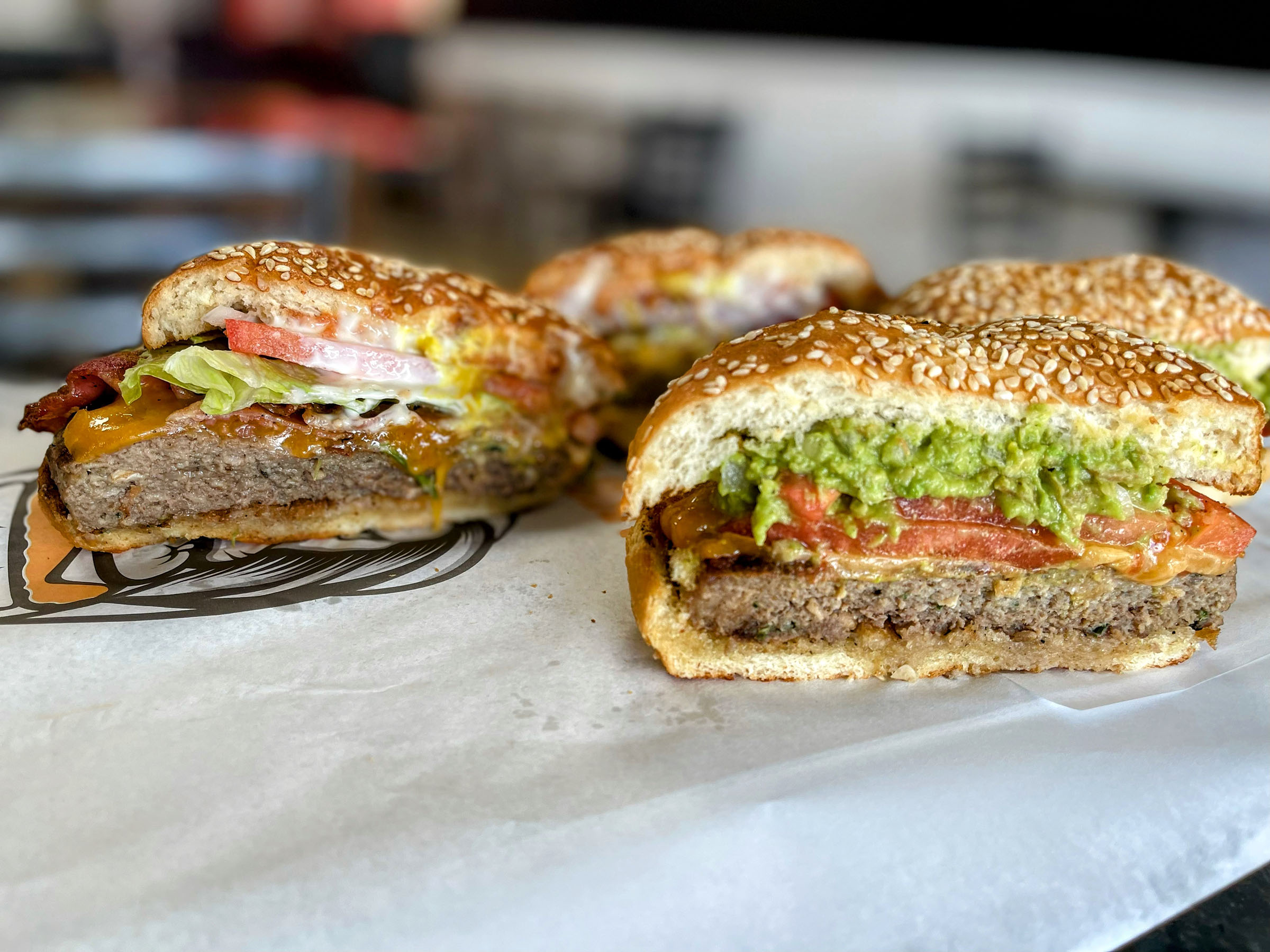 color photo of burger with guacamole