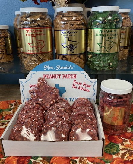 A box of peanut brittle clusters in a cardboard box