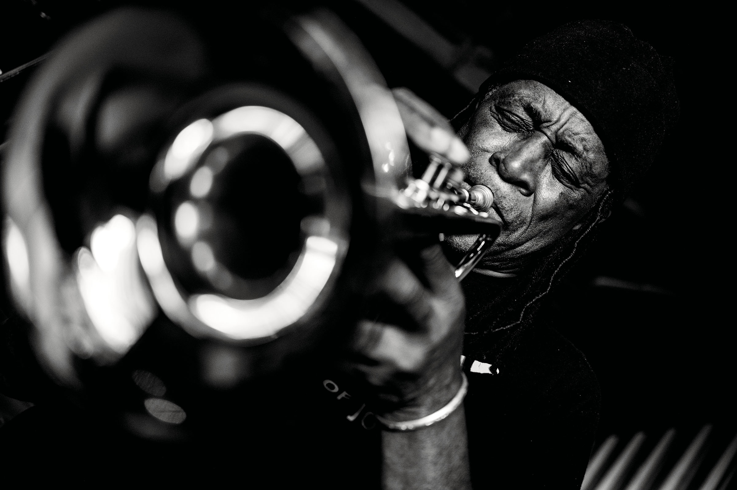 A black and white picture of a man playing a trumpet