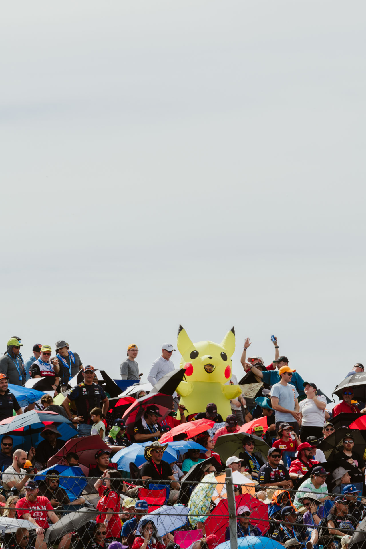 A large inflatable Pikachu is the focal point of this image of a crowd of race fans