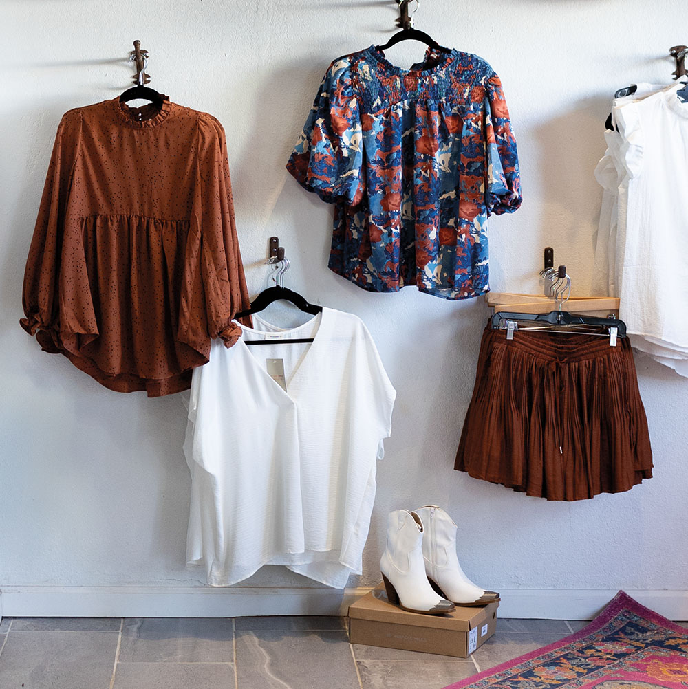 A collection of clothing hanging on a white wall
