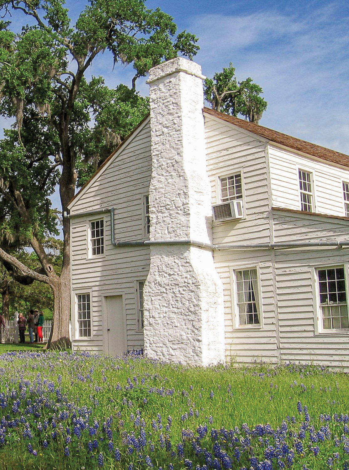 A white house with a brick chimney
