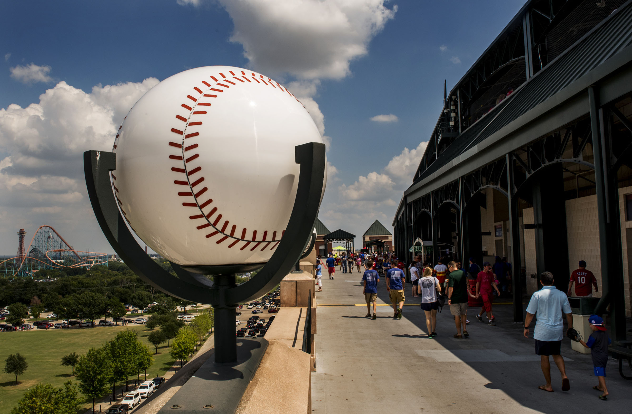A large baseball sculpture outside of a ballpark