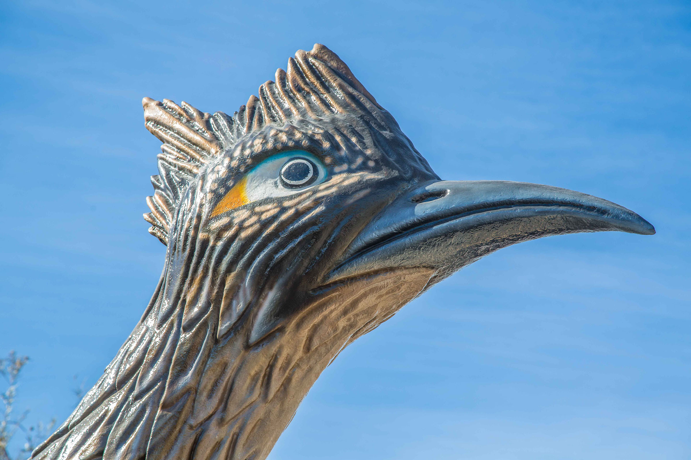 A close-up of the head of a statue of a bird.