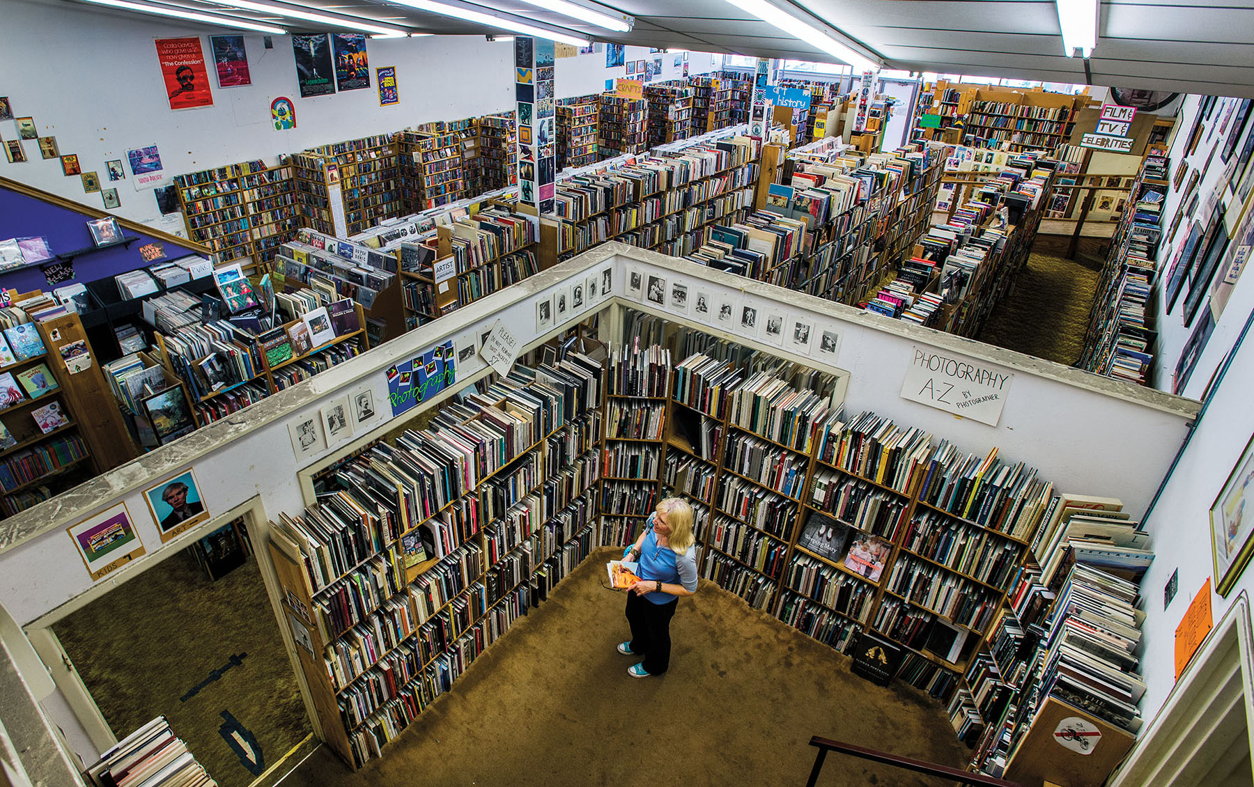 An overhead view of a woman browsing in a large bookstore