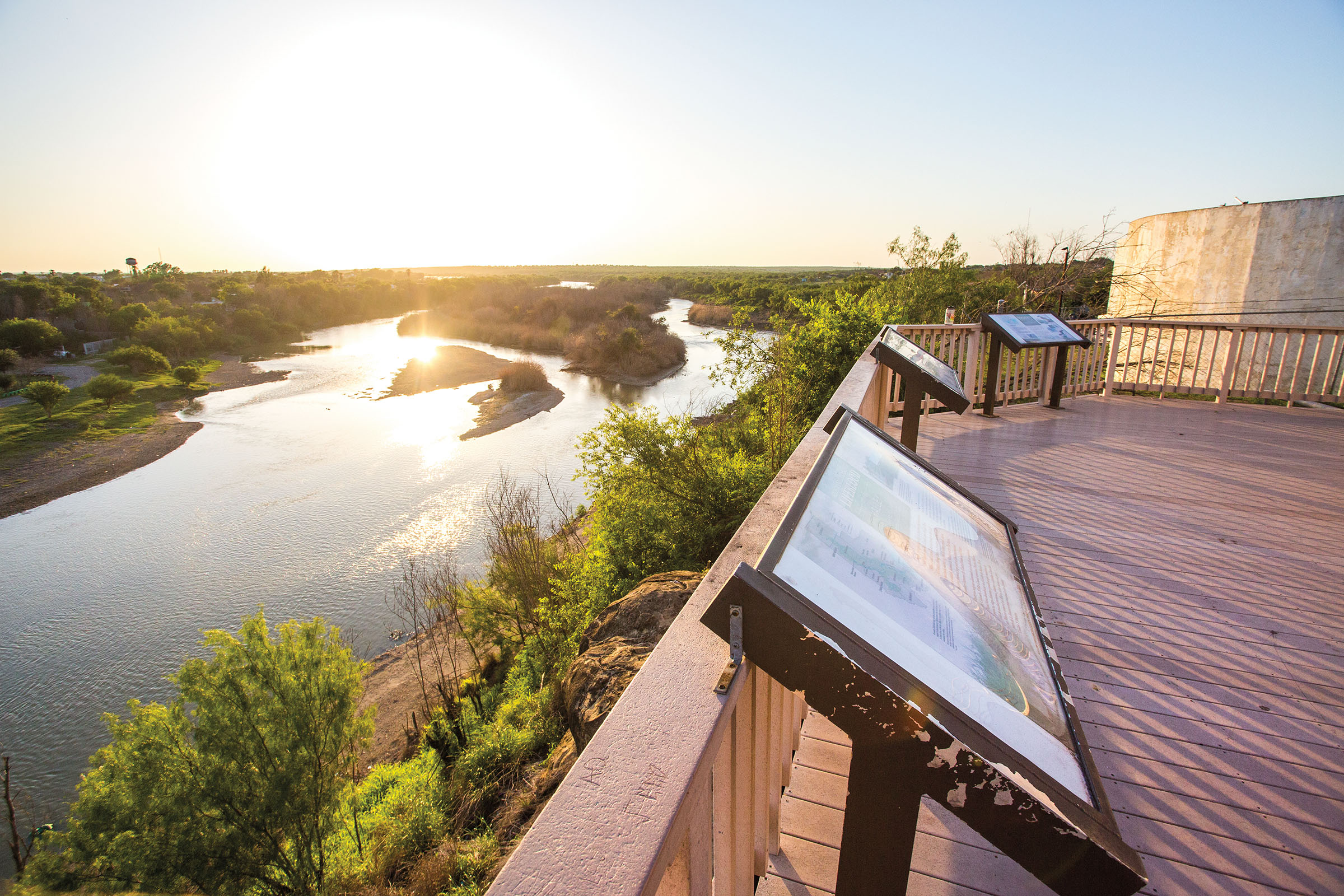 Interpretive signs on a deck overlooking a large marshland