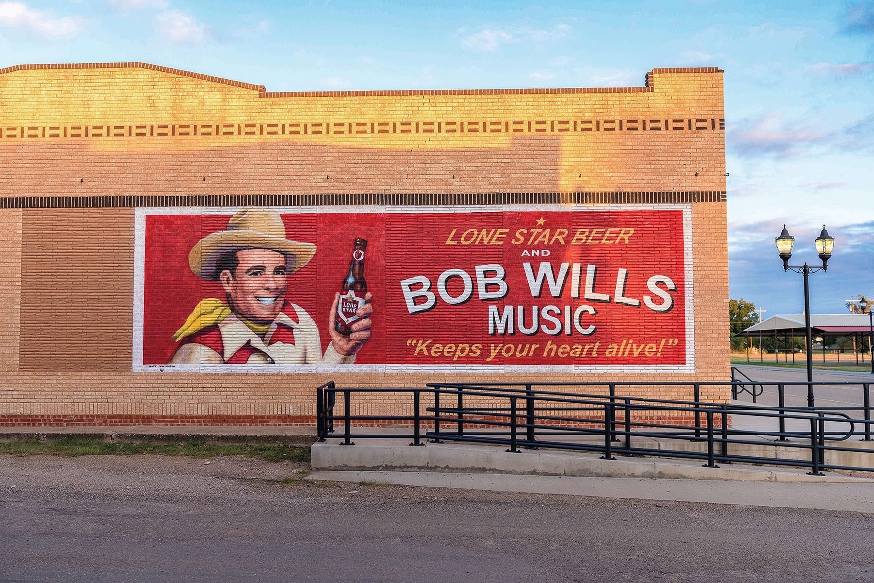 A large red mural reading "Lone Star Beer and Bob Wills Music Keeps your Heart Alive"
