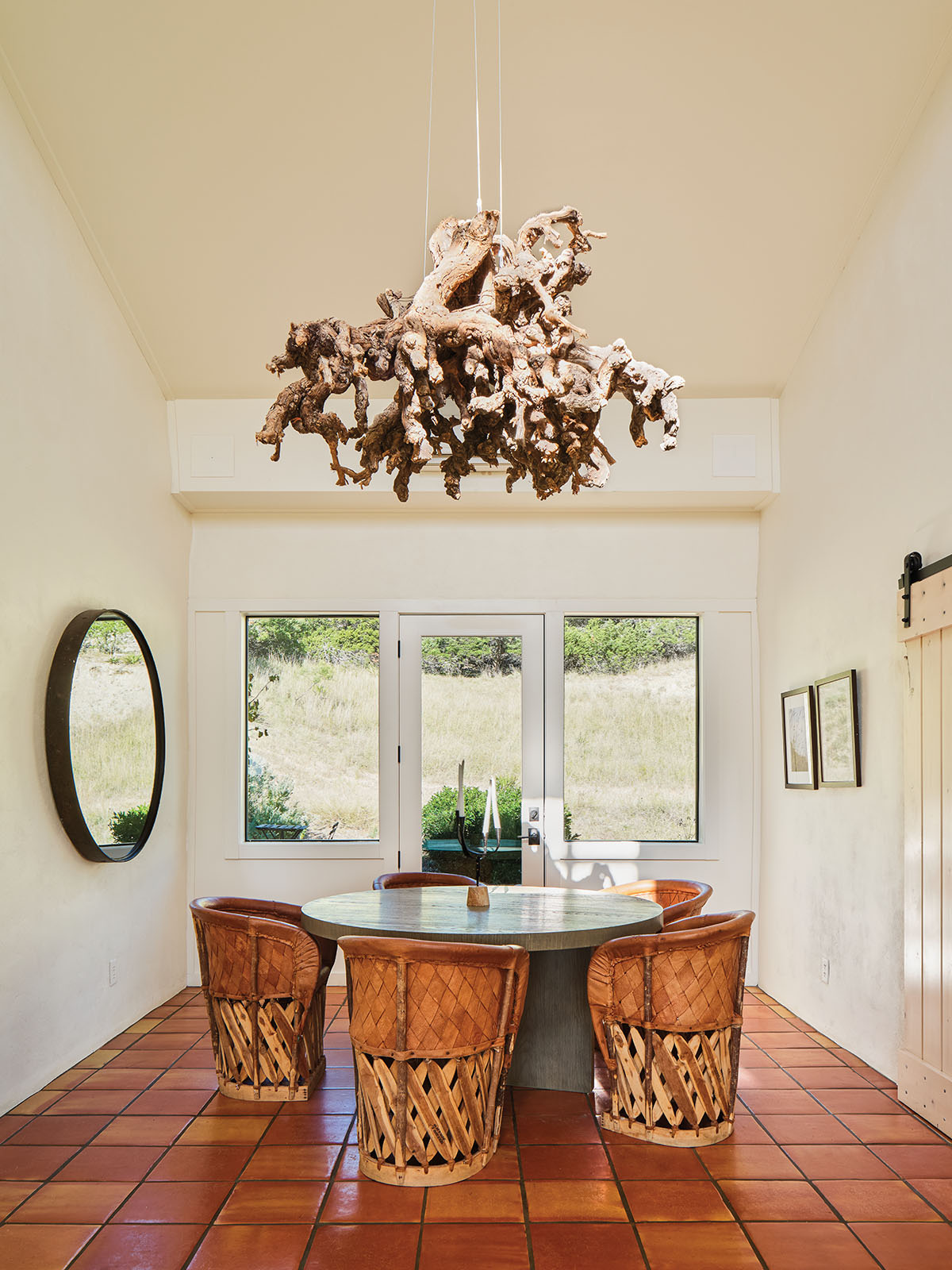 The interior of a room with wooden furniture and a large driftwood chandelier 