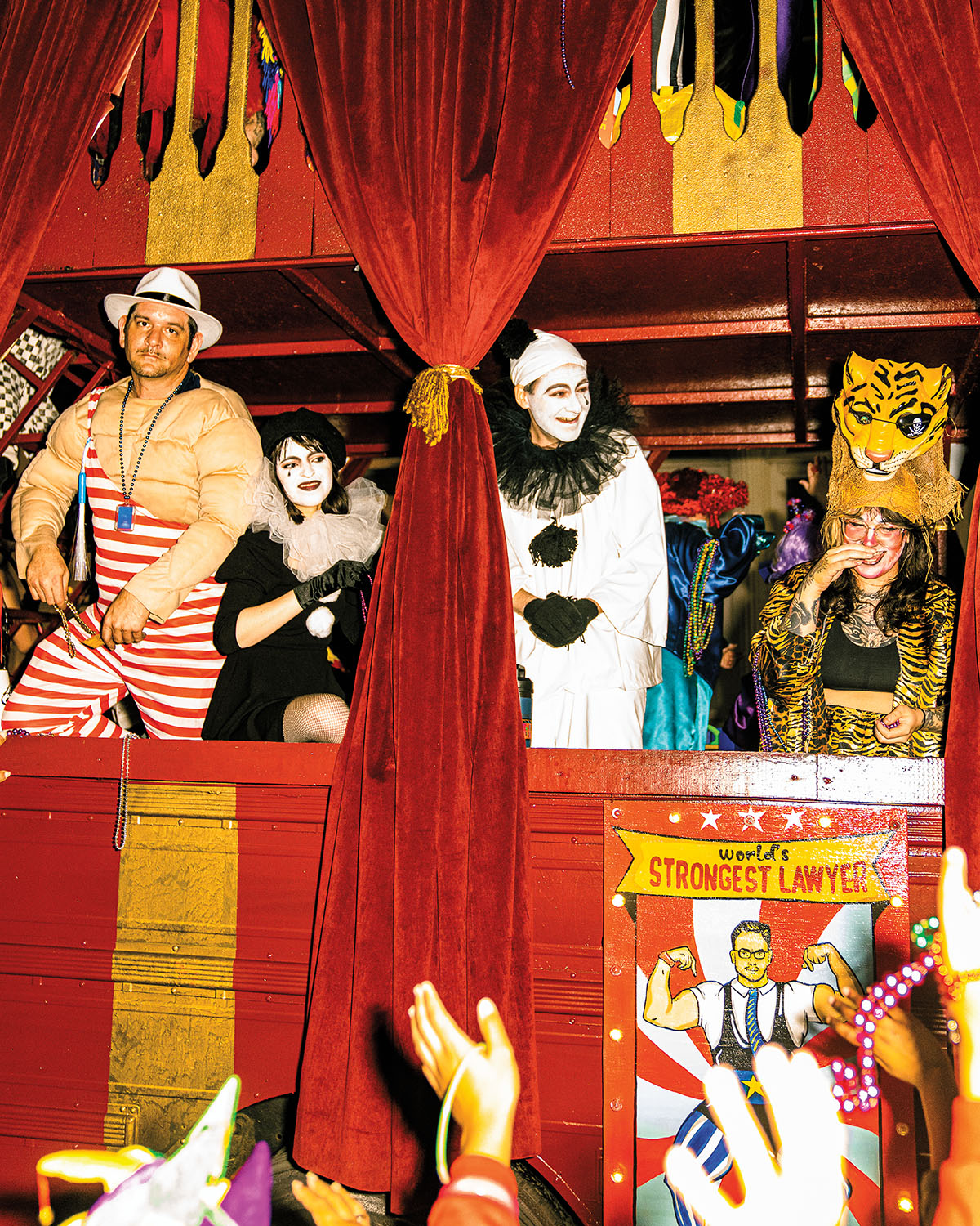 A group of people dressed in red and white carnival attire on a float