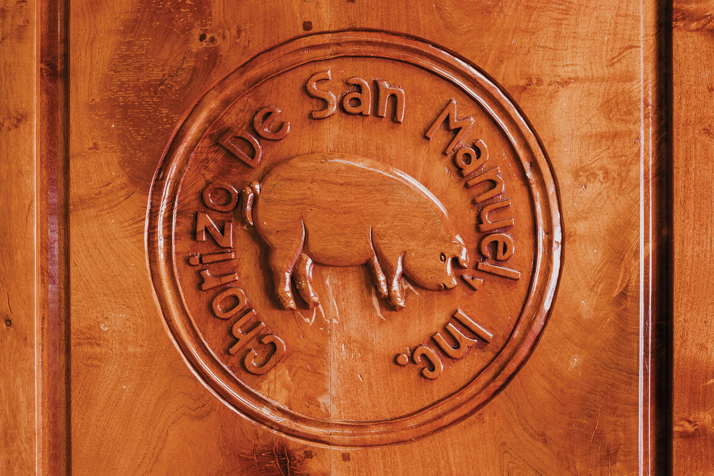 A leather stamped logo for Chorizo de San Manuel