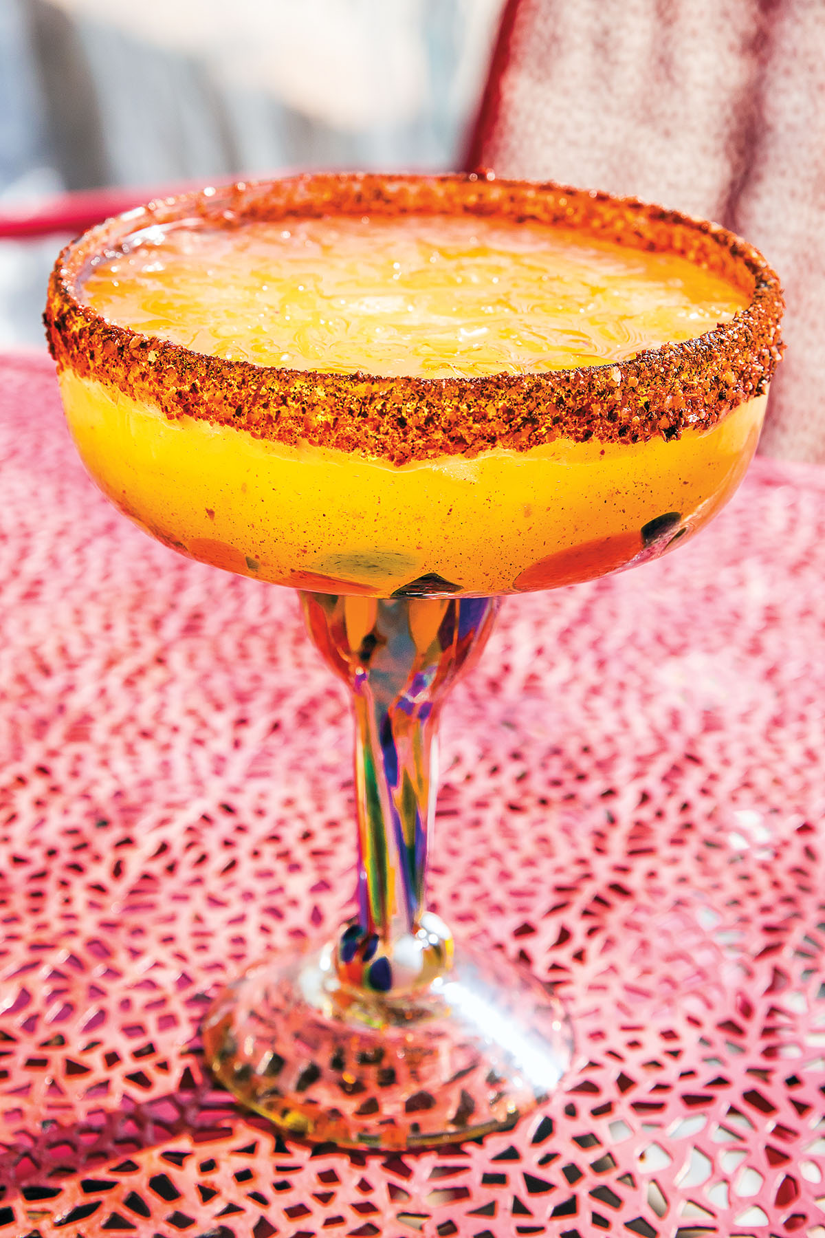 A bright orange drink with an orange rim