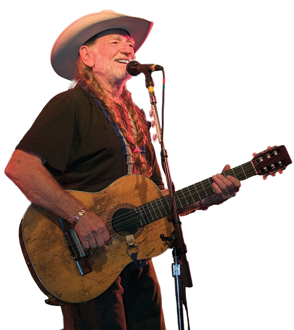 A man in a cowboy hat singing into a microphone
