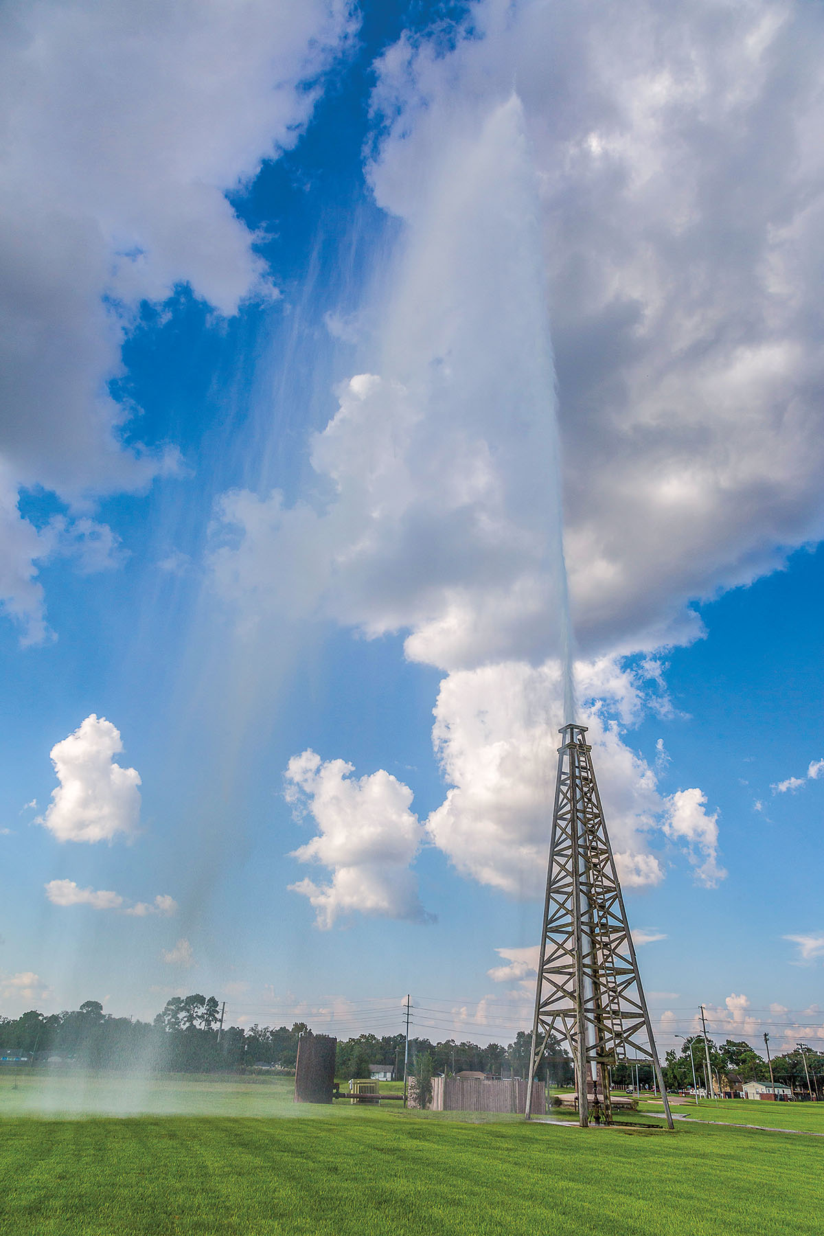 A tall steel structure spewing water from the top