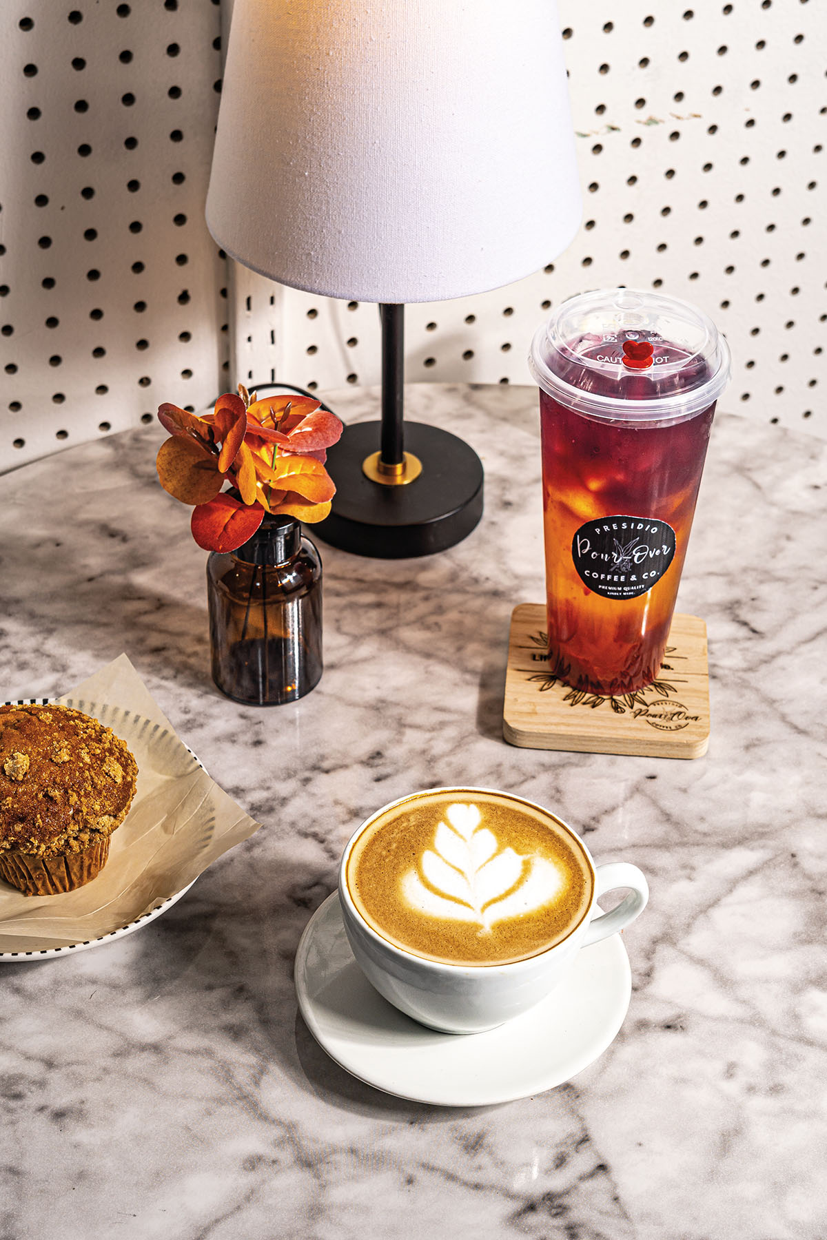 A collection of coffees and treats on a marble countertop