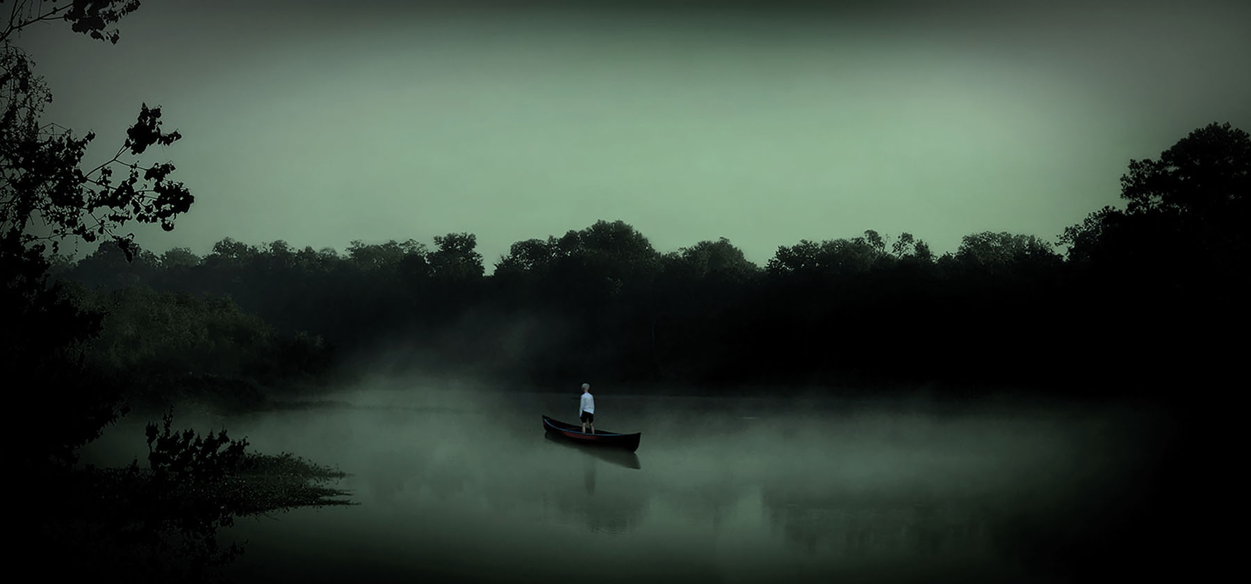 An artistic rendering of green light and a boat floating in water beside trees