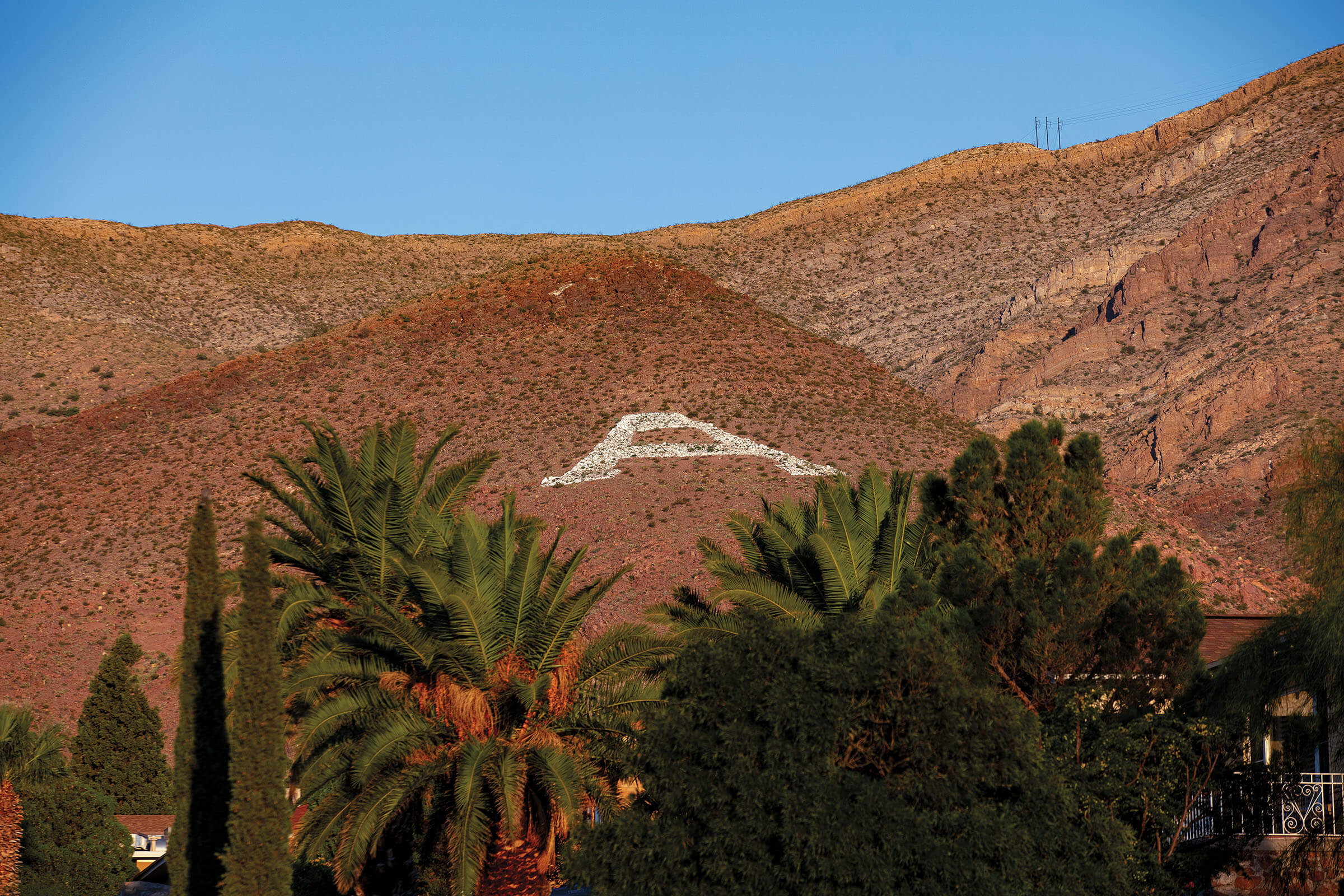 A brown hillside with a white "A" painted