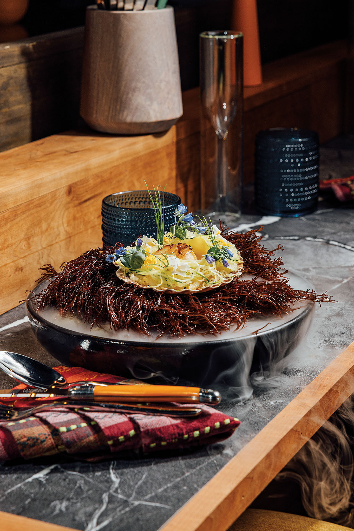 A stone bowl with dark filling and an egg-like topping