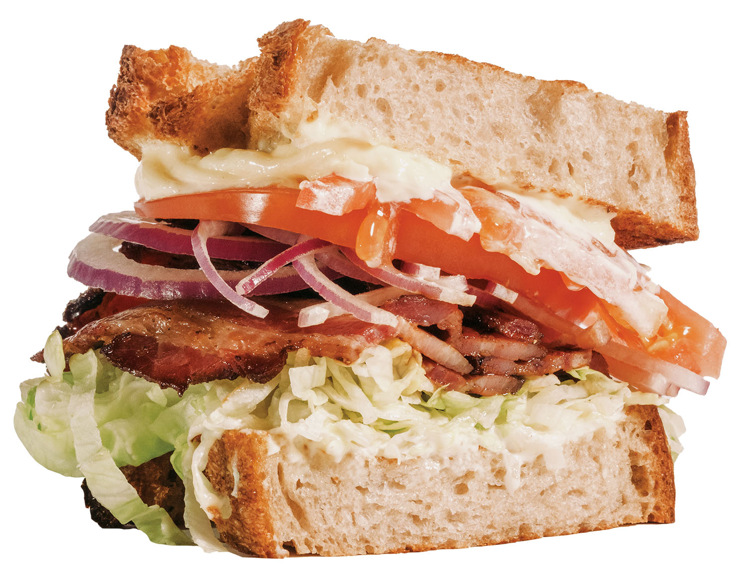 A sandwich piled high with meat and vegetables on crusty bread