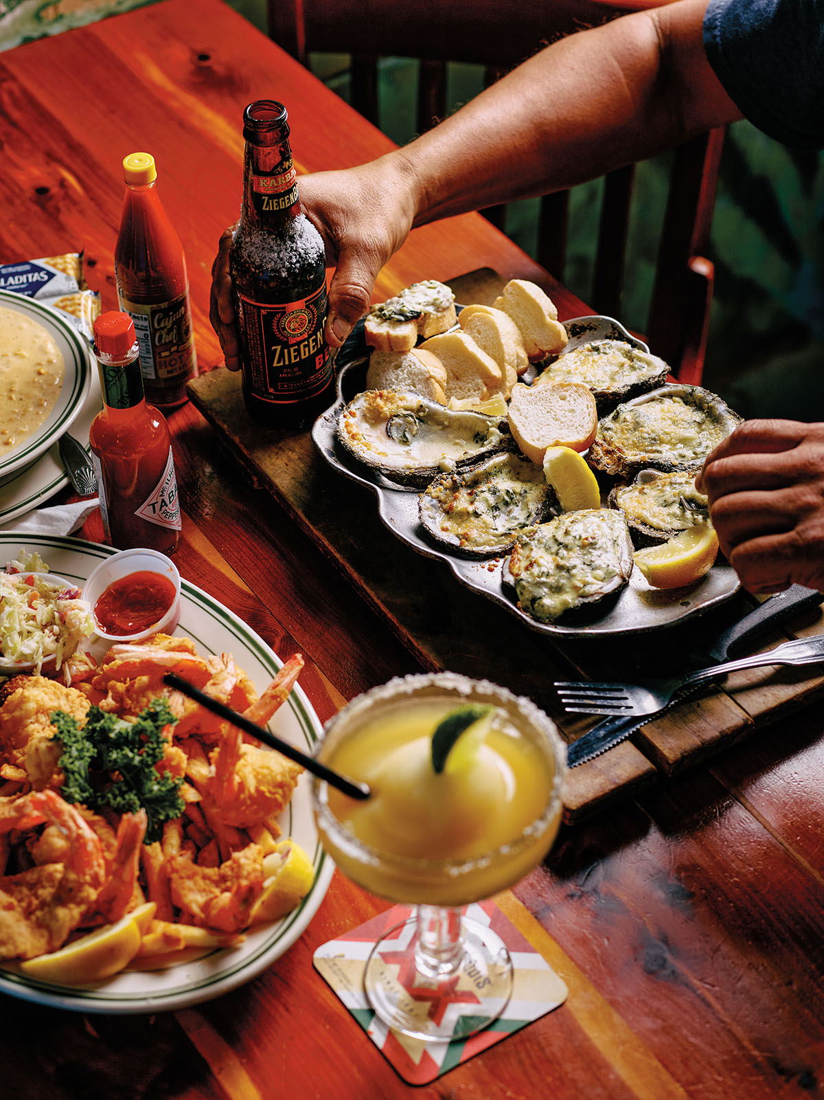 A platter of oysters and other seafood dishes on a red tablecloth