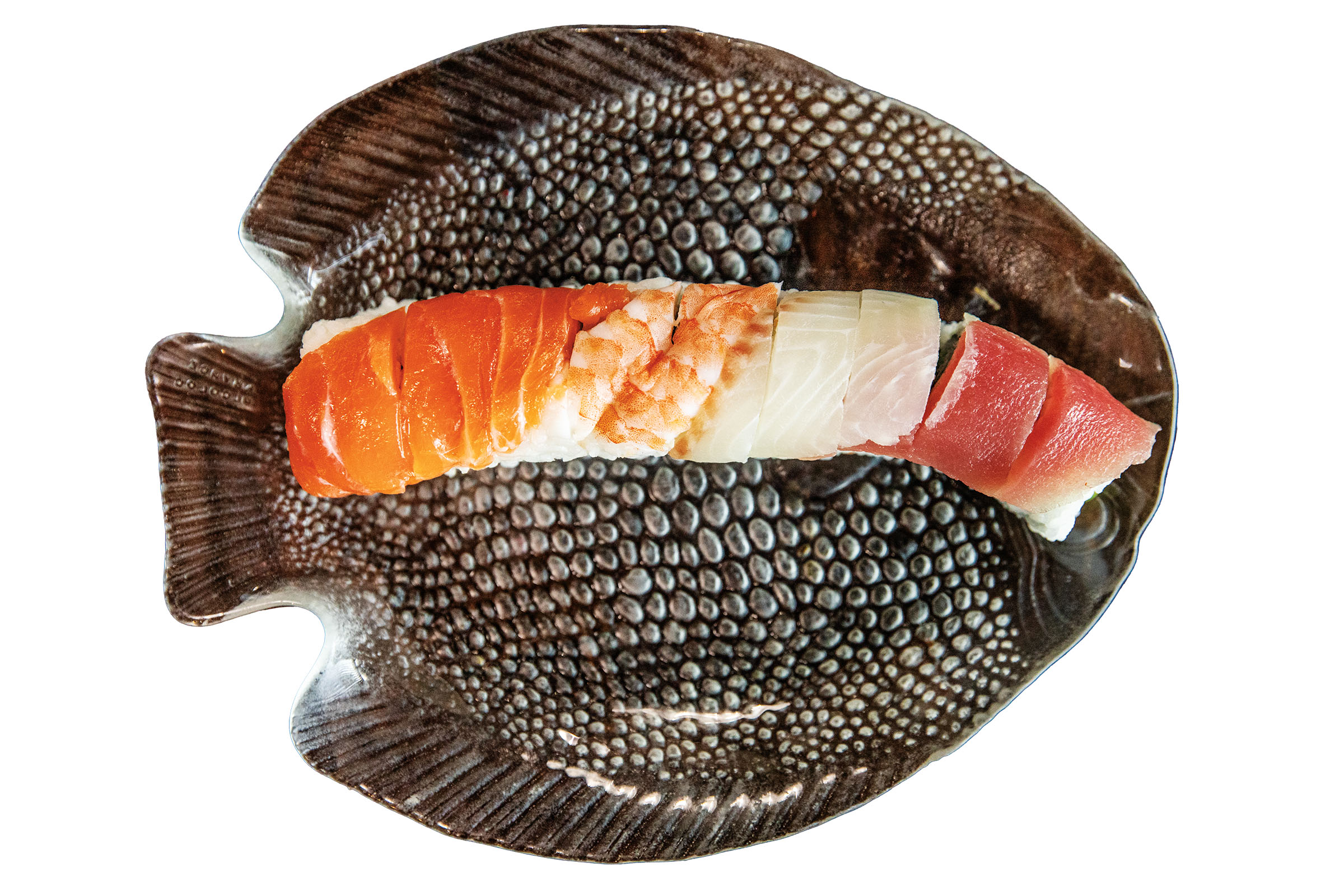 Slices of brightly-colored raw fish on rice served on a metal fish-shaped platter