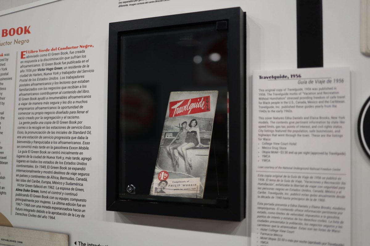 A 1956 edition of Travelguide behind a display case