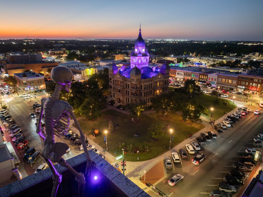 An aerial shot of a courthouse illuminated purple