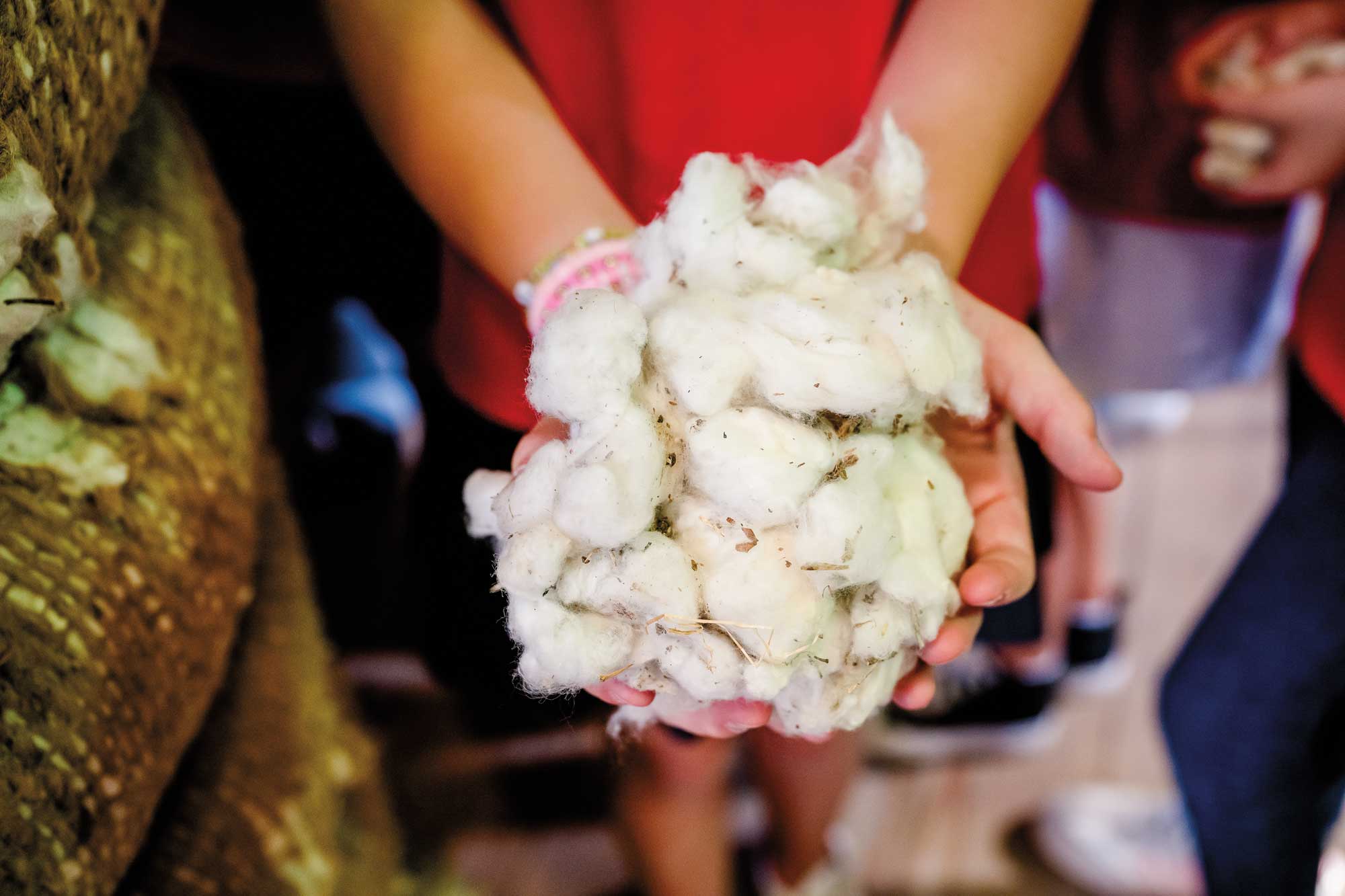 A person holding wads of cotton