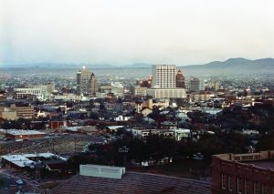 A city skyline with mountains behind