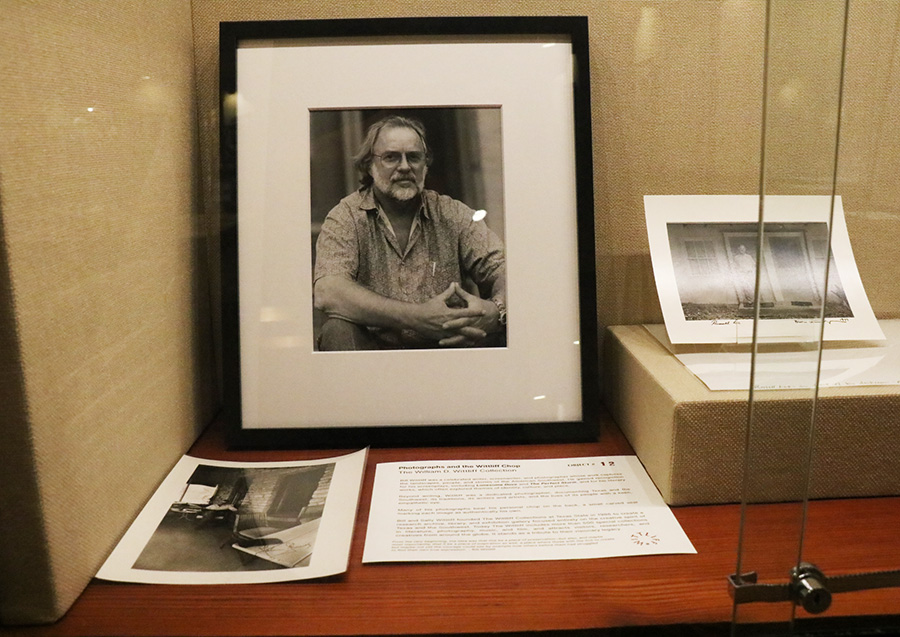 A framed photo of a man in a museum display case