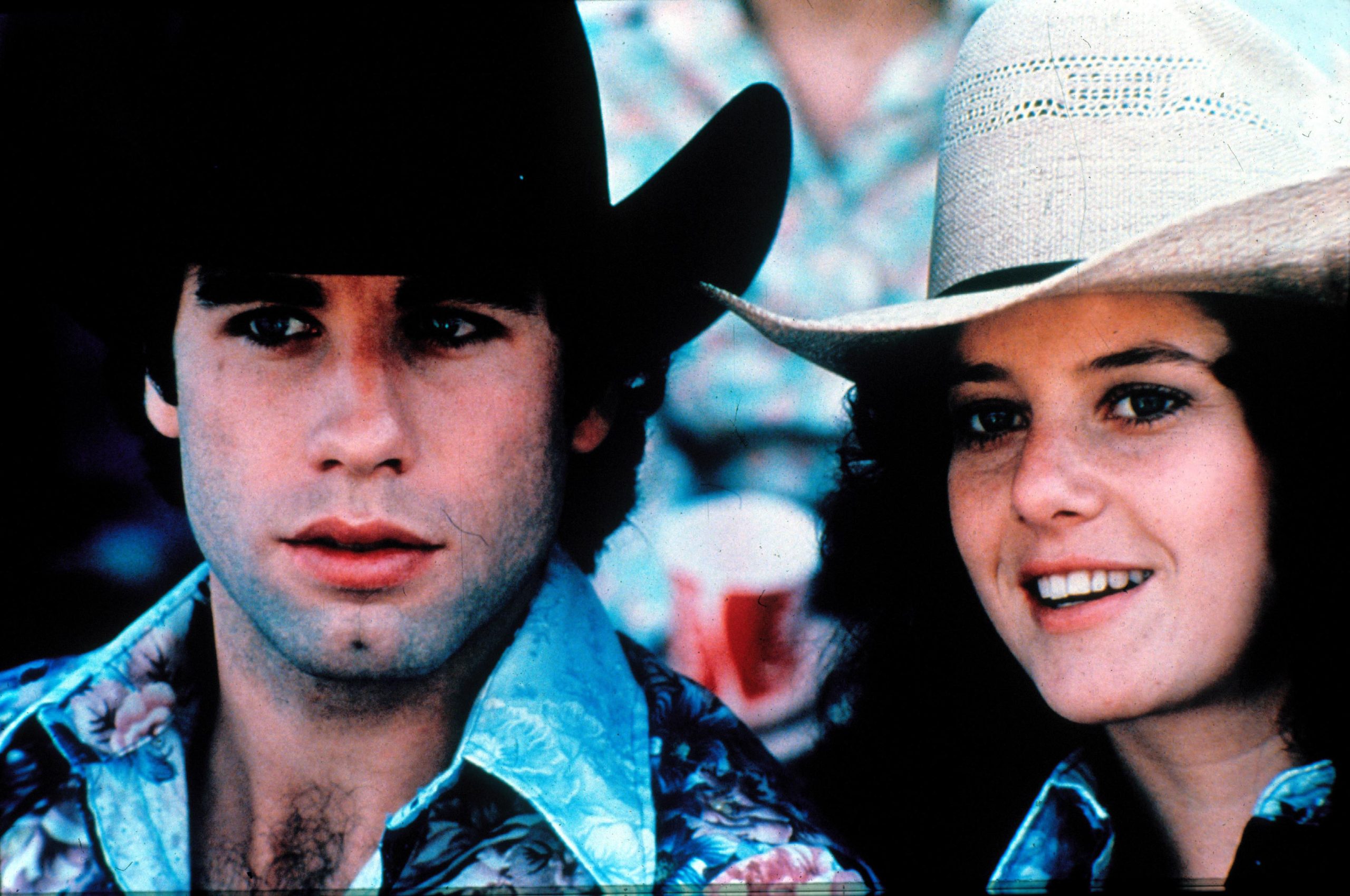 A man and a woman, the man wearing a black cowboy hat and the woman wearing a white cowboy hat
